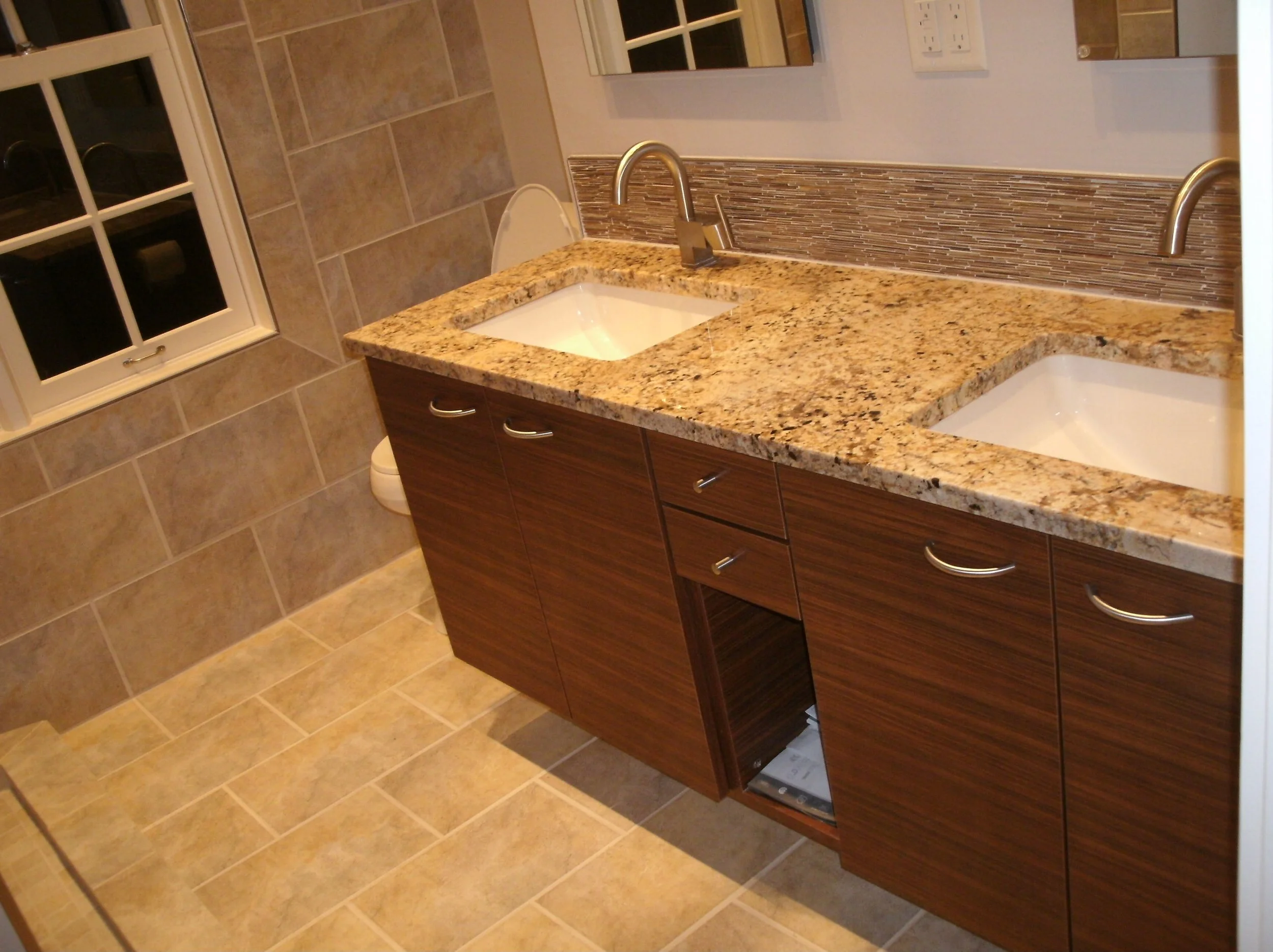 Tiled floor and window wall, tile backsplash over cabinet counter installed.