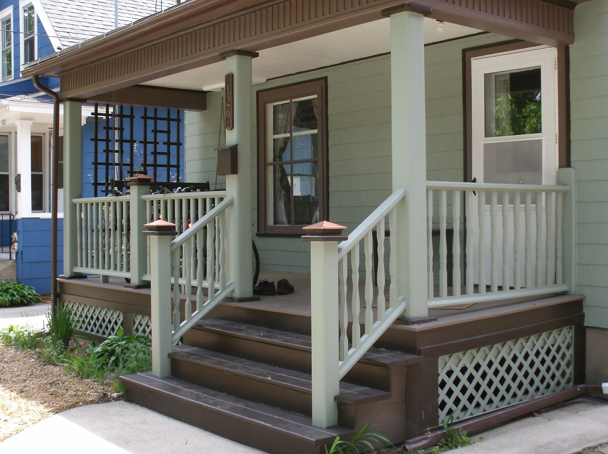 View of new posts, rails, decking, stairs, upper trim, all painted