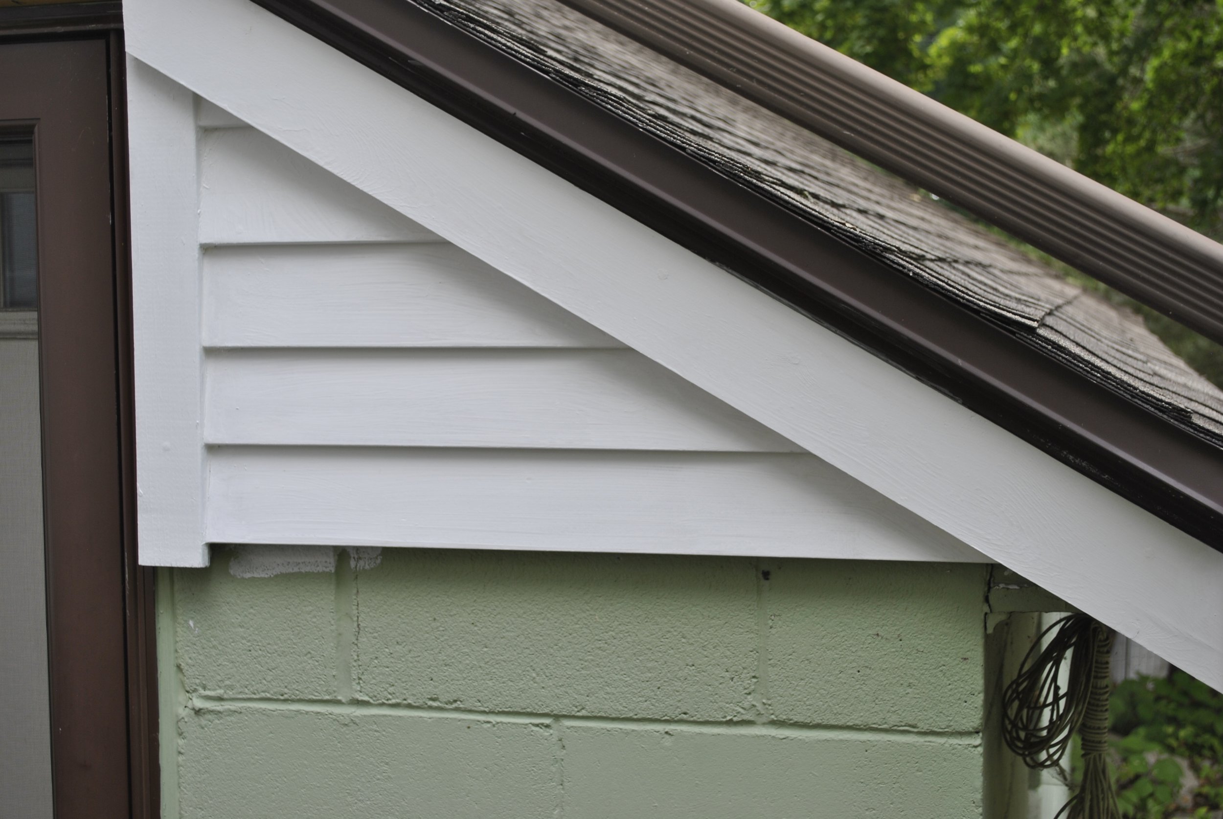 Another view of the new wood on the garage wall next to storm door.