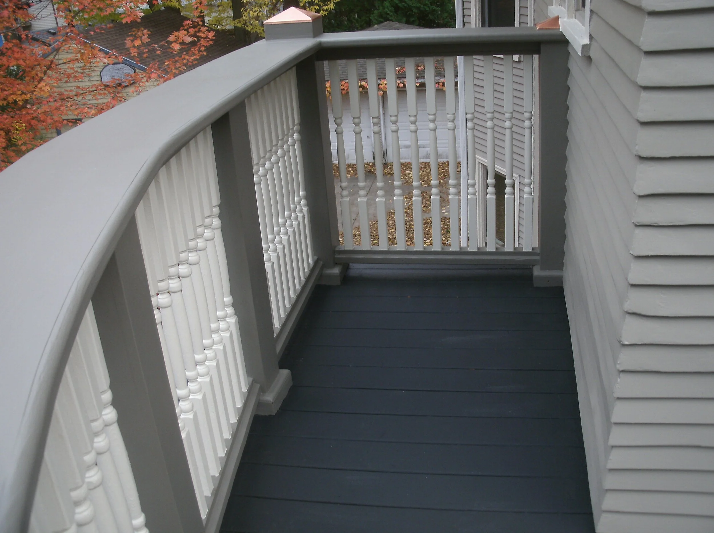 First view of the railing top installed and painted from on the deck.