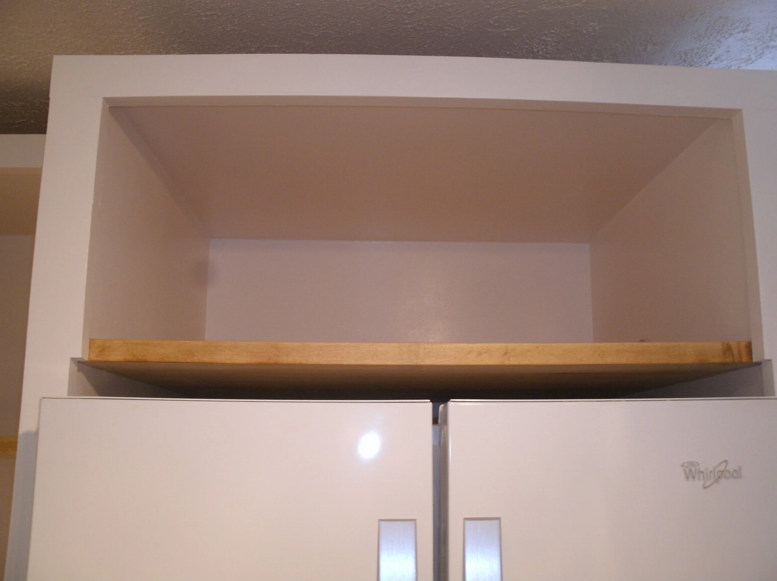 Close-up of the shelf above the refrigerator