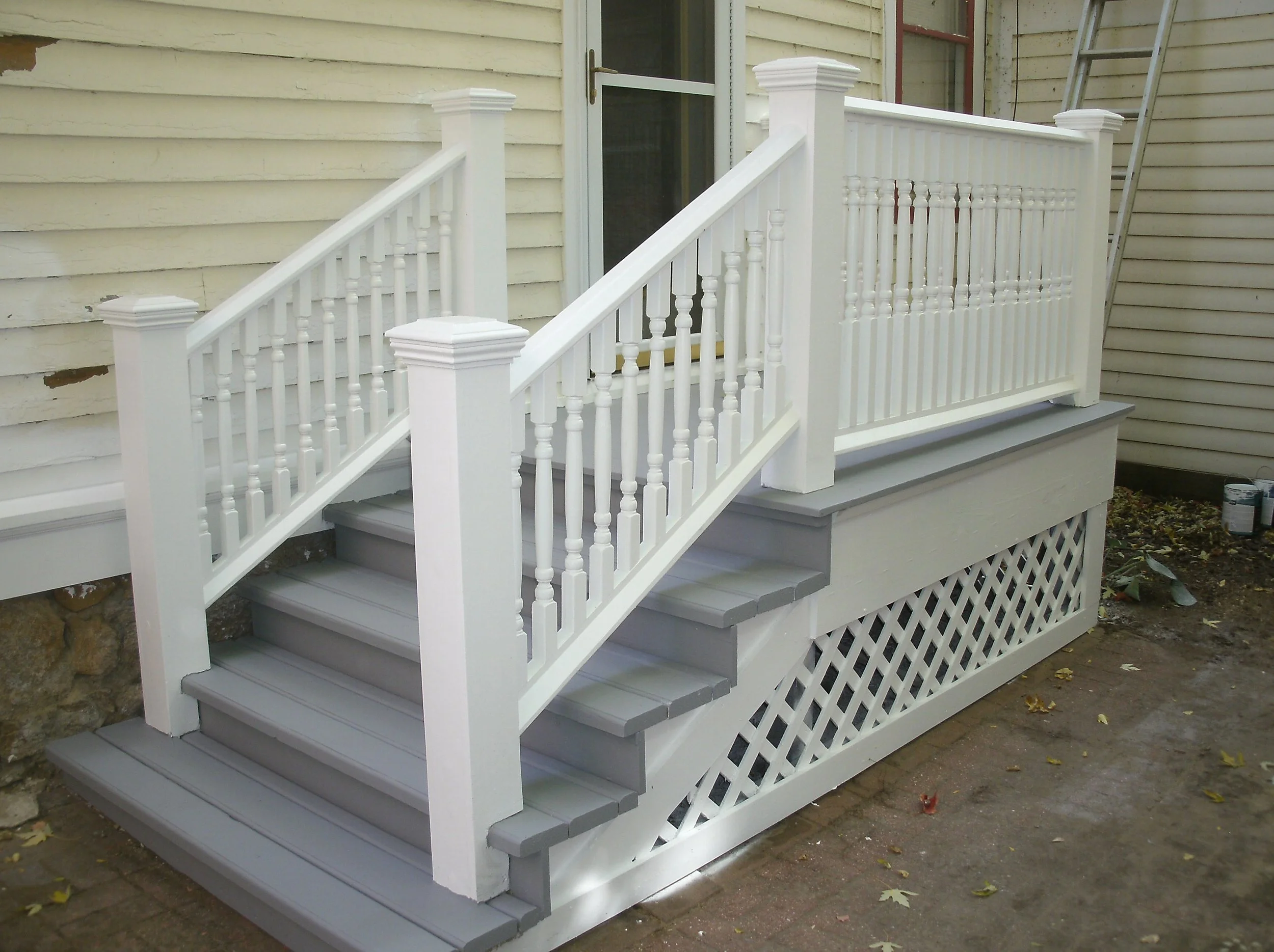 Full front view of the stairs, landing, rails and rebuilt drip edge-siding bottom