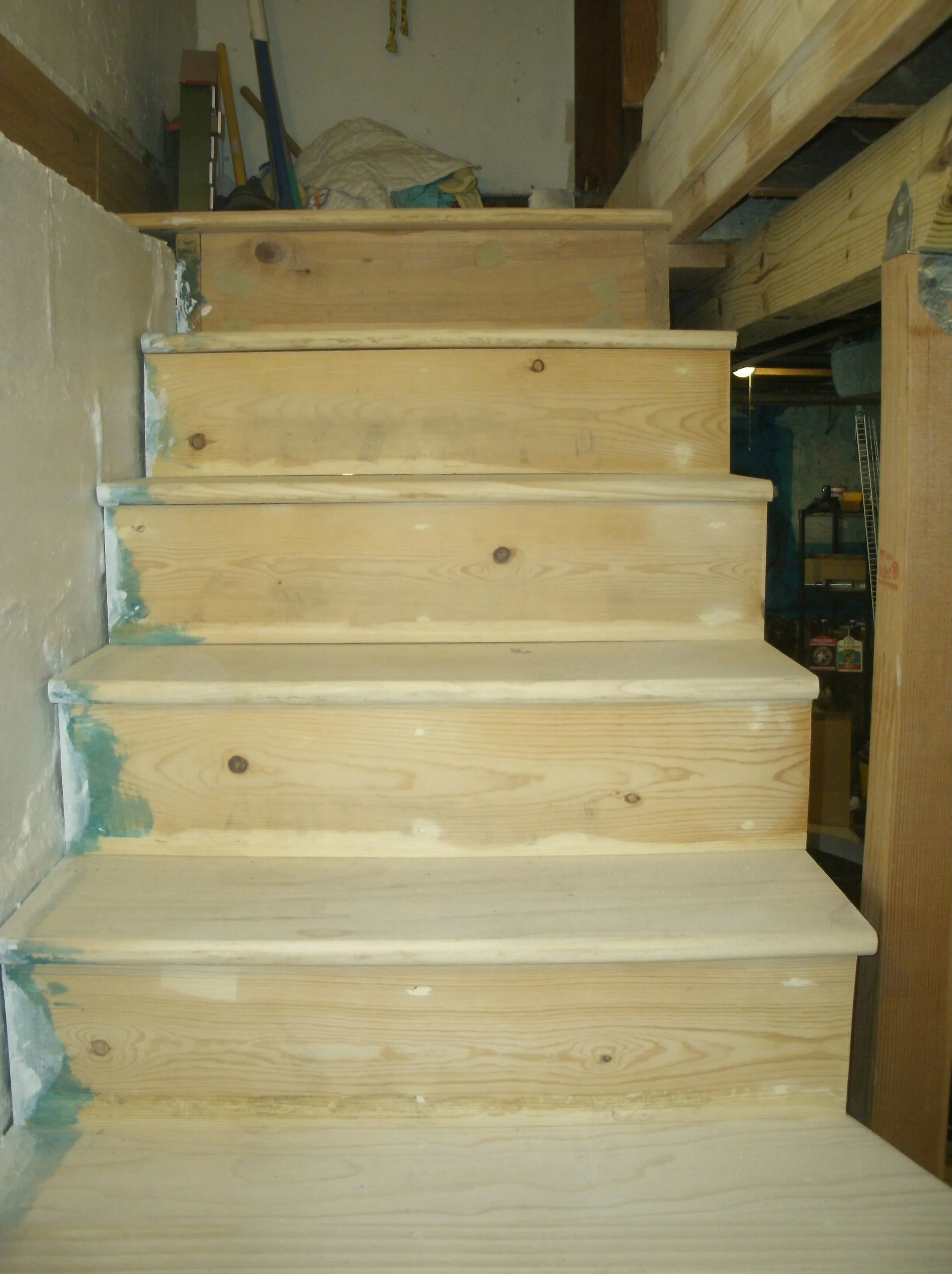 New stairs, all ends of risers and treads sealed as they are against the foundation
