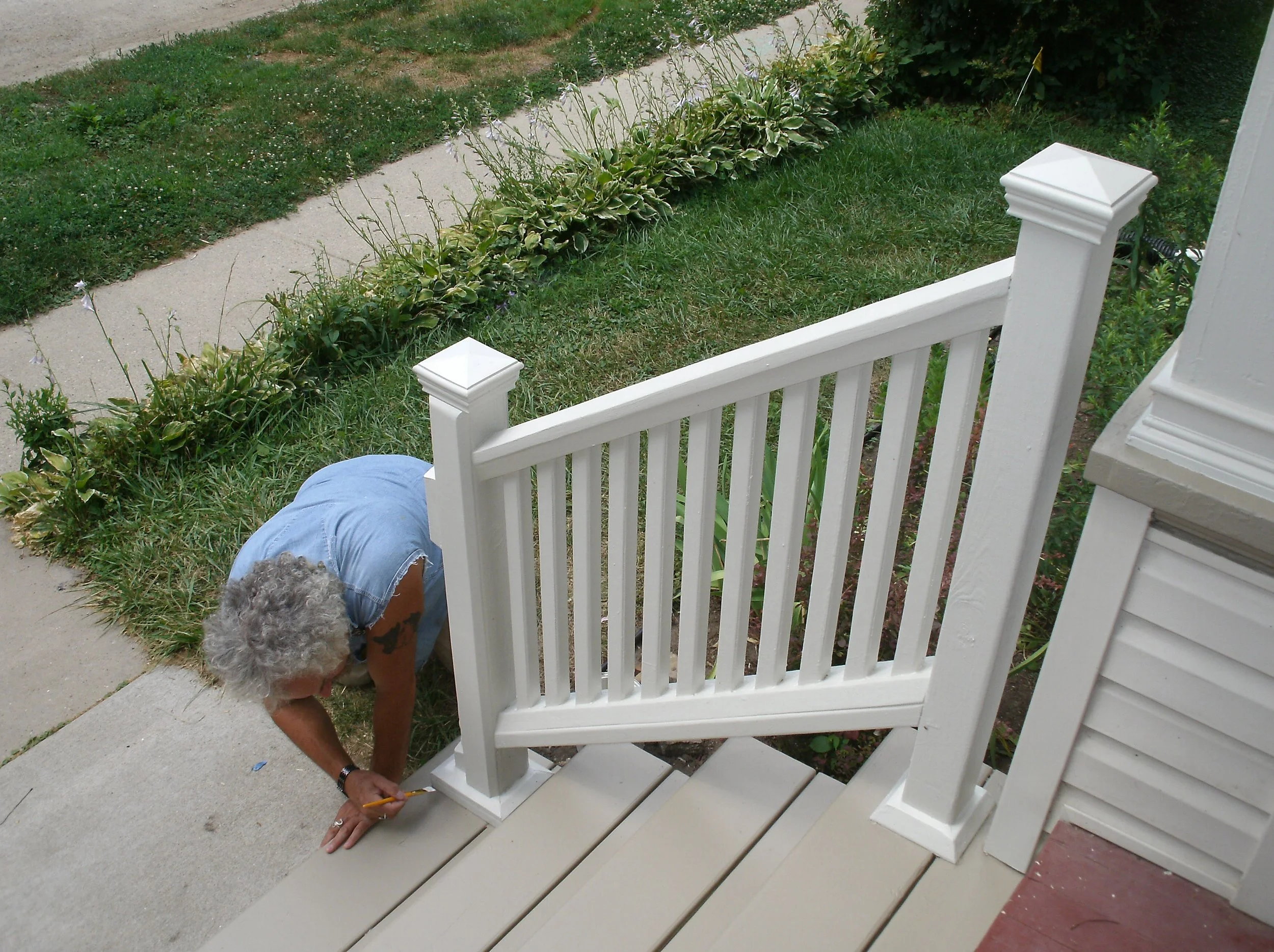 Close up of myself, touching up painted front stairs.	
