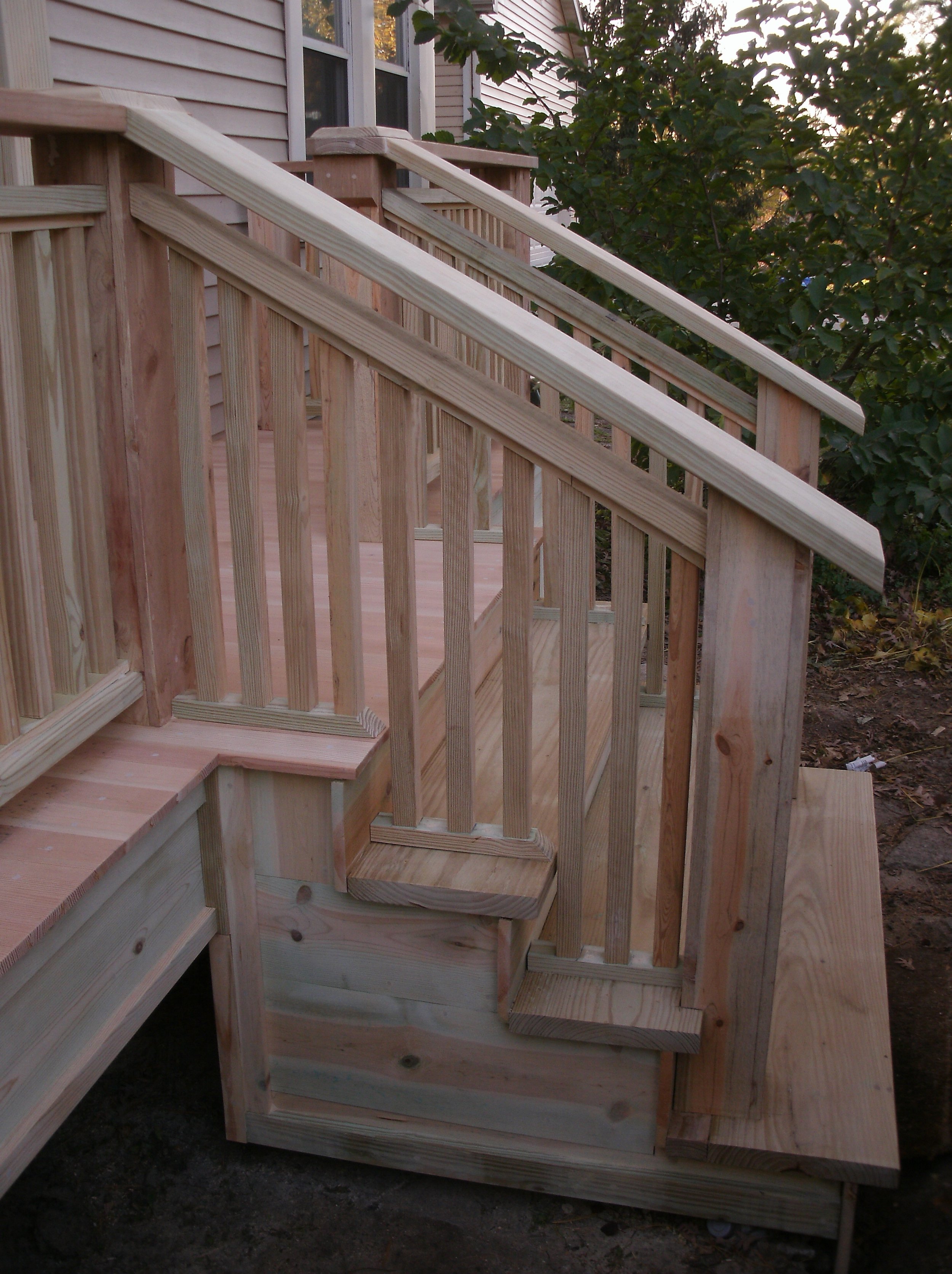 A view of the stairs, rails, and trim under stairs