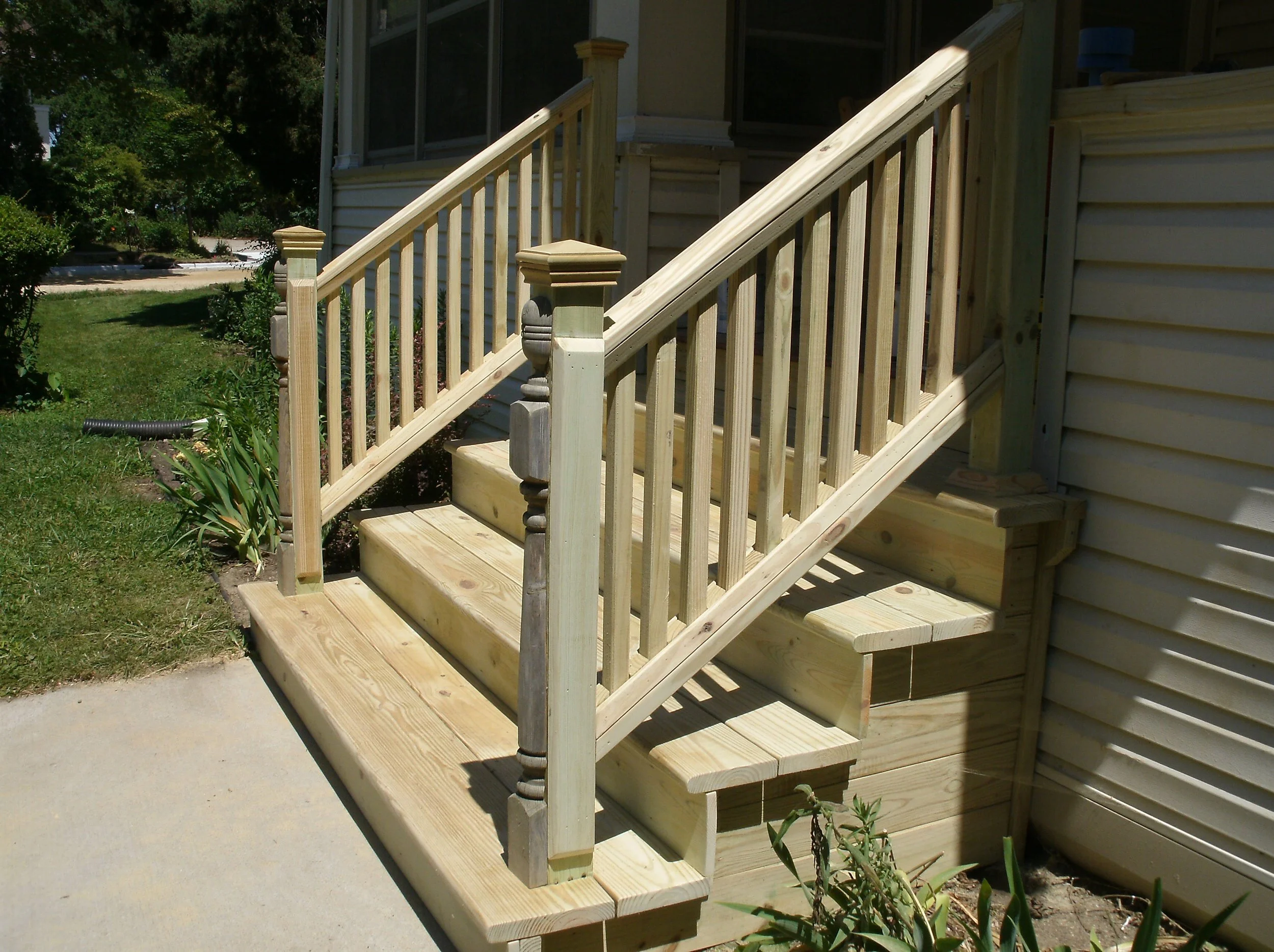 New front stairs. Note decorative post ripped in half and applied to front of newell posts	