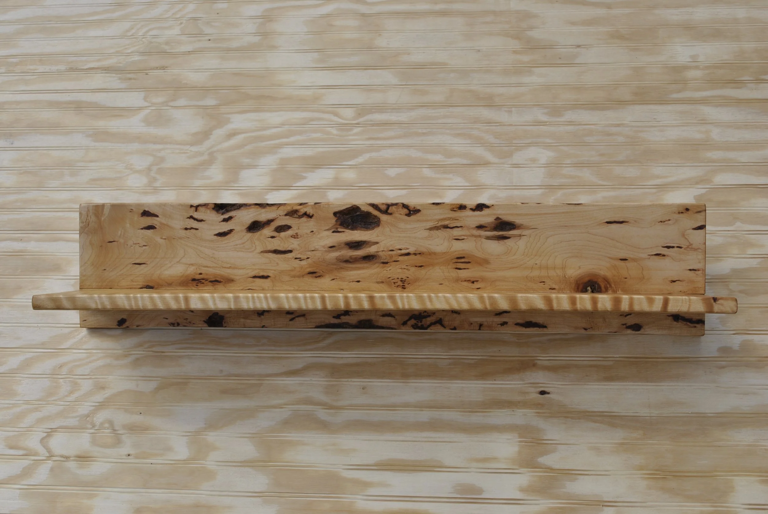 Top view of a wooden box on a light wood table.