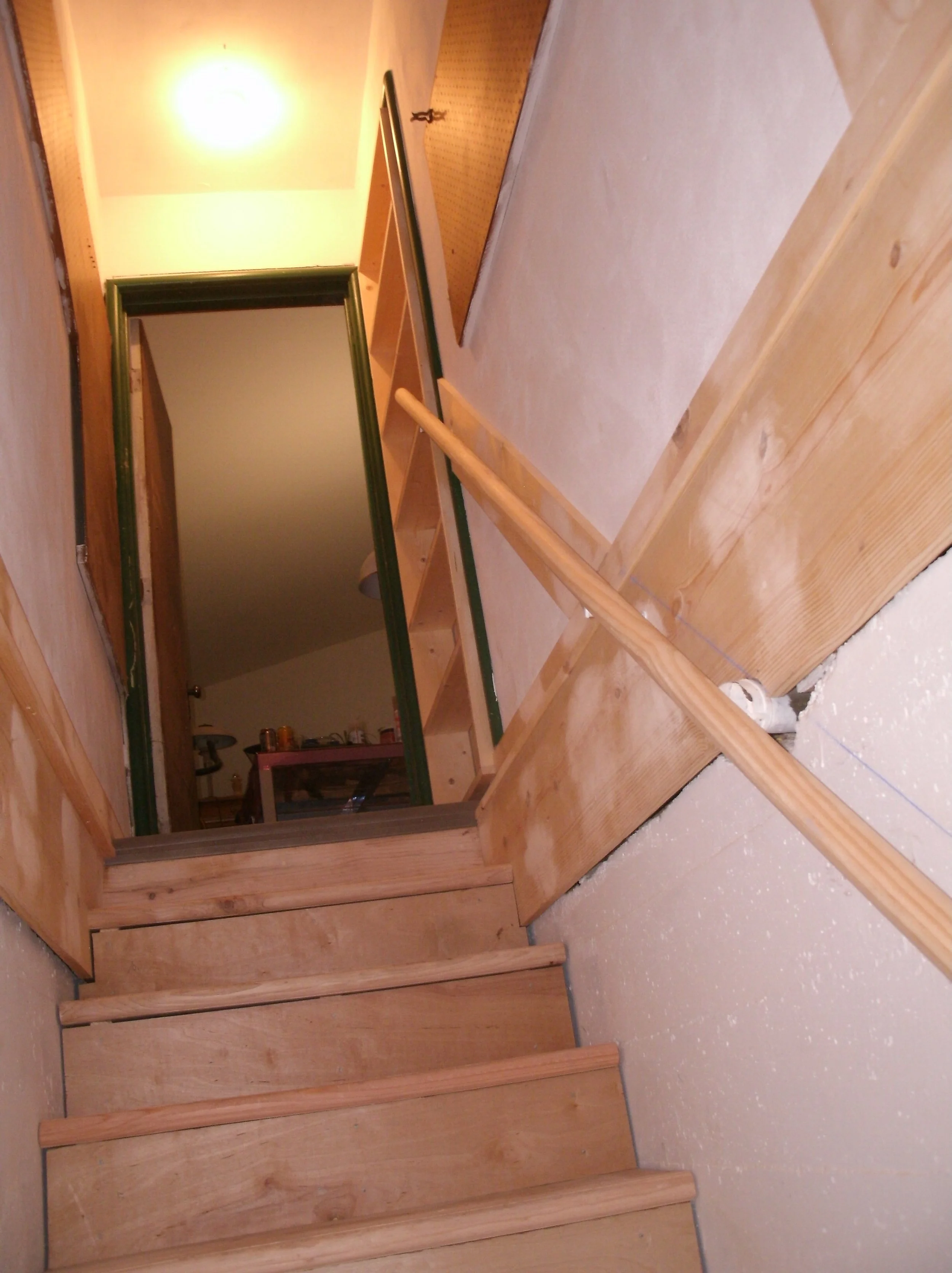 View of the top of the new stairs, cap trim, pantry shelves, and handrail