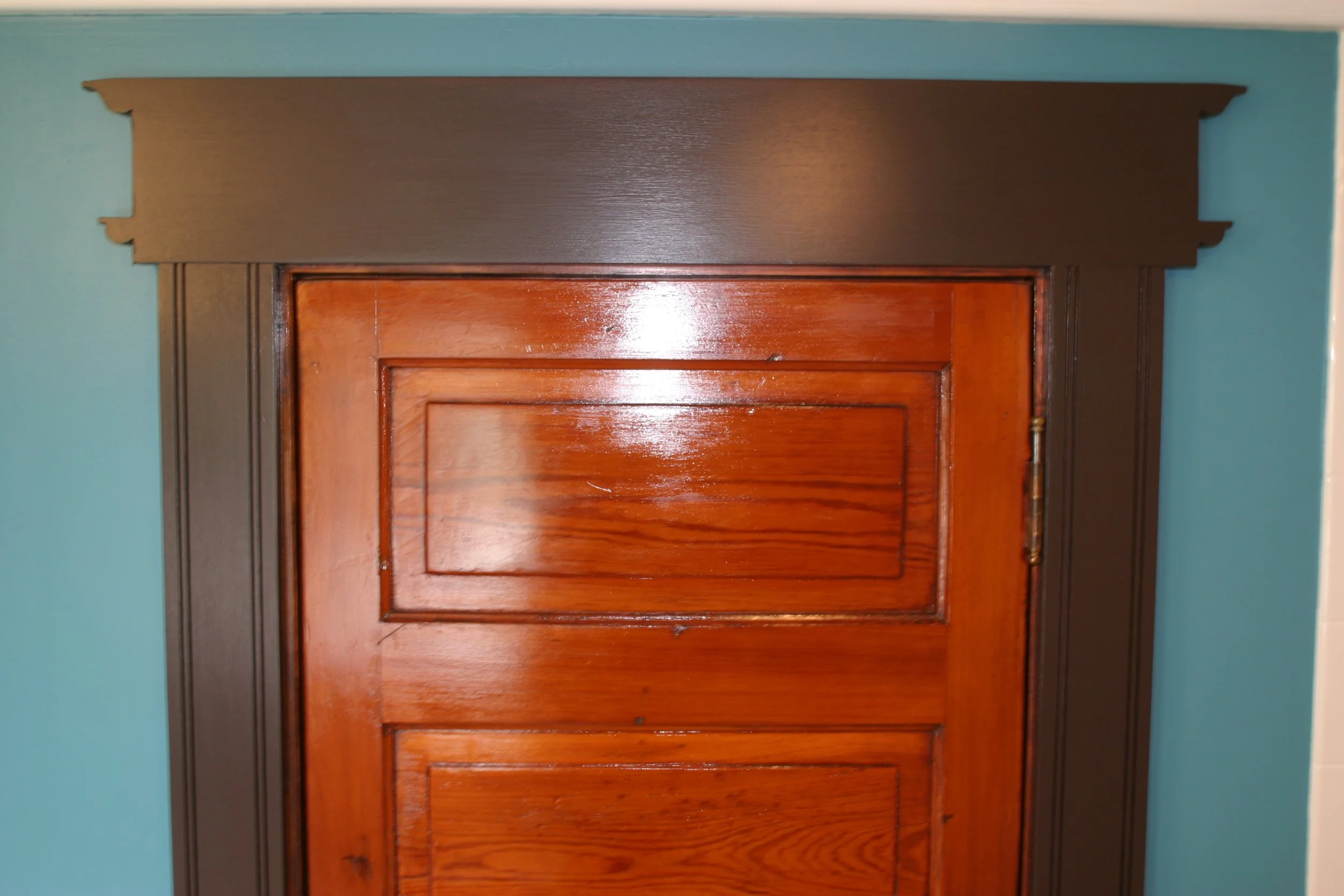 Stained and sealed door and Victorian–ish trim.