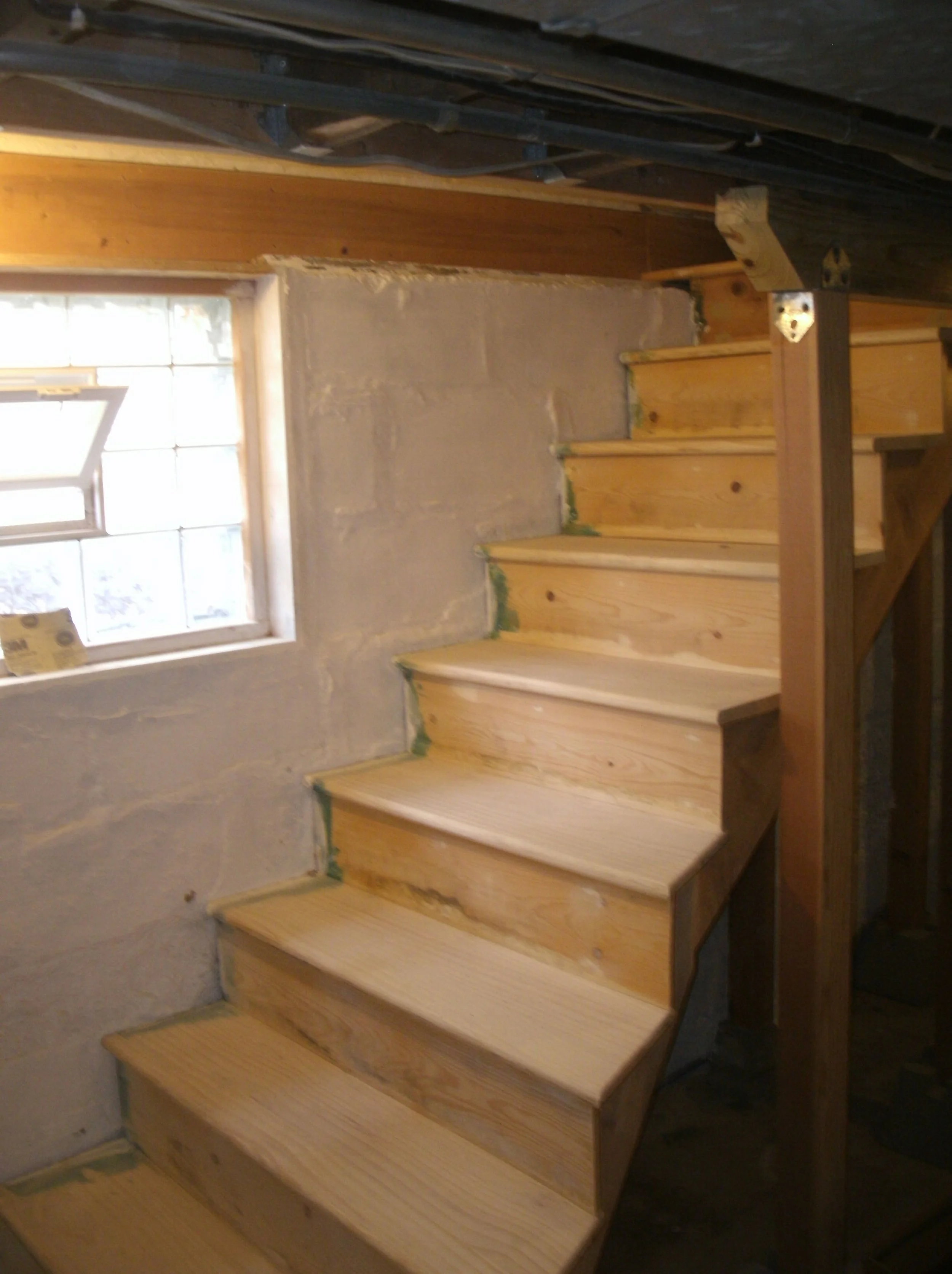 New stairs with view of new glass block window unit