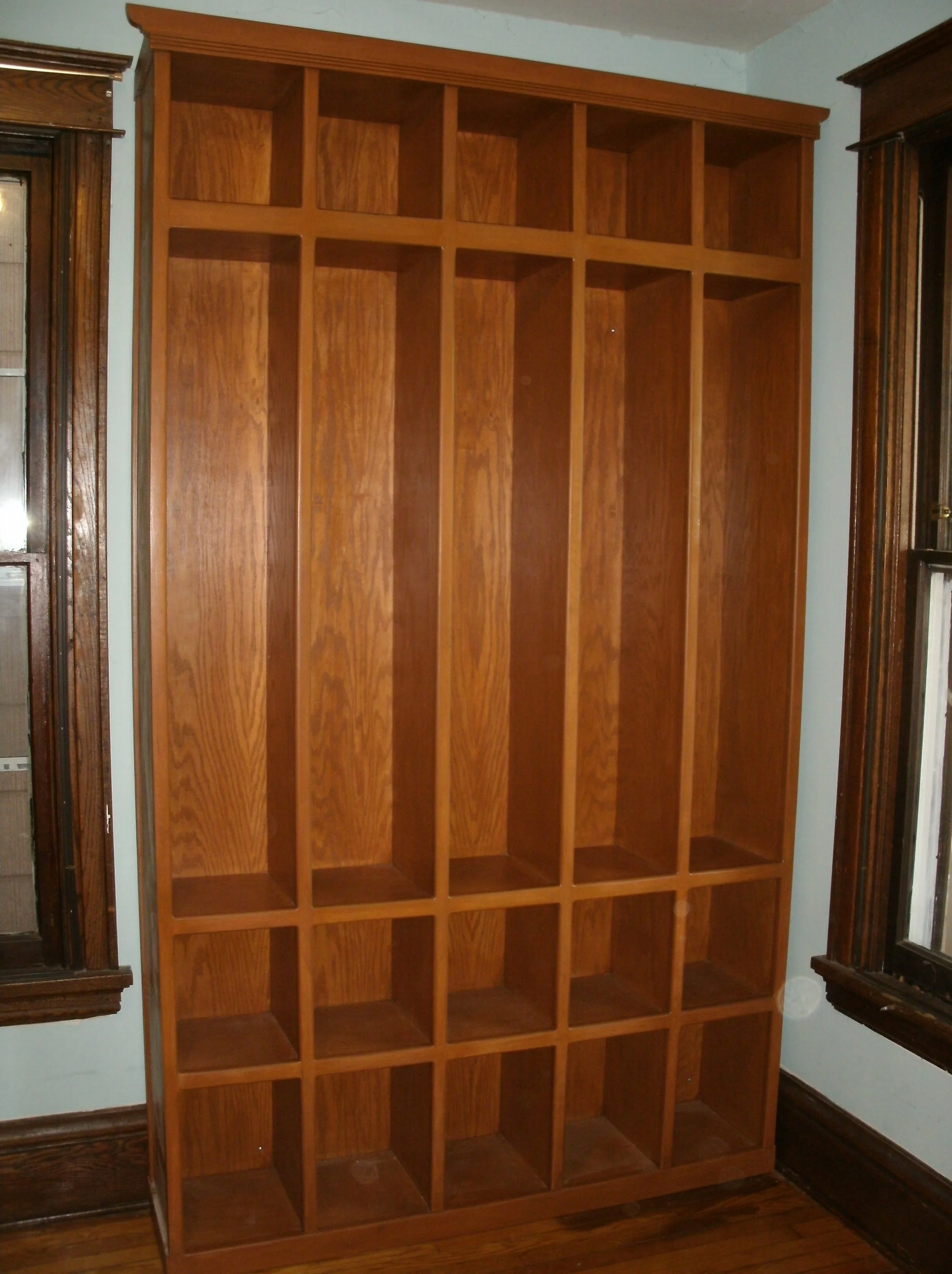 Entry hall oak-faced coat and boots storage unit installed