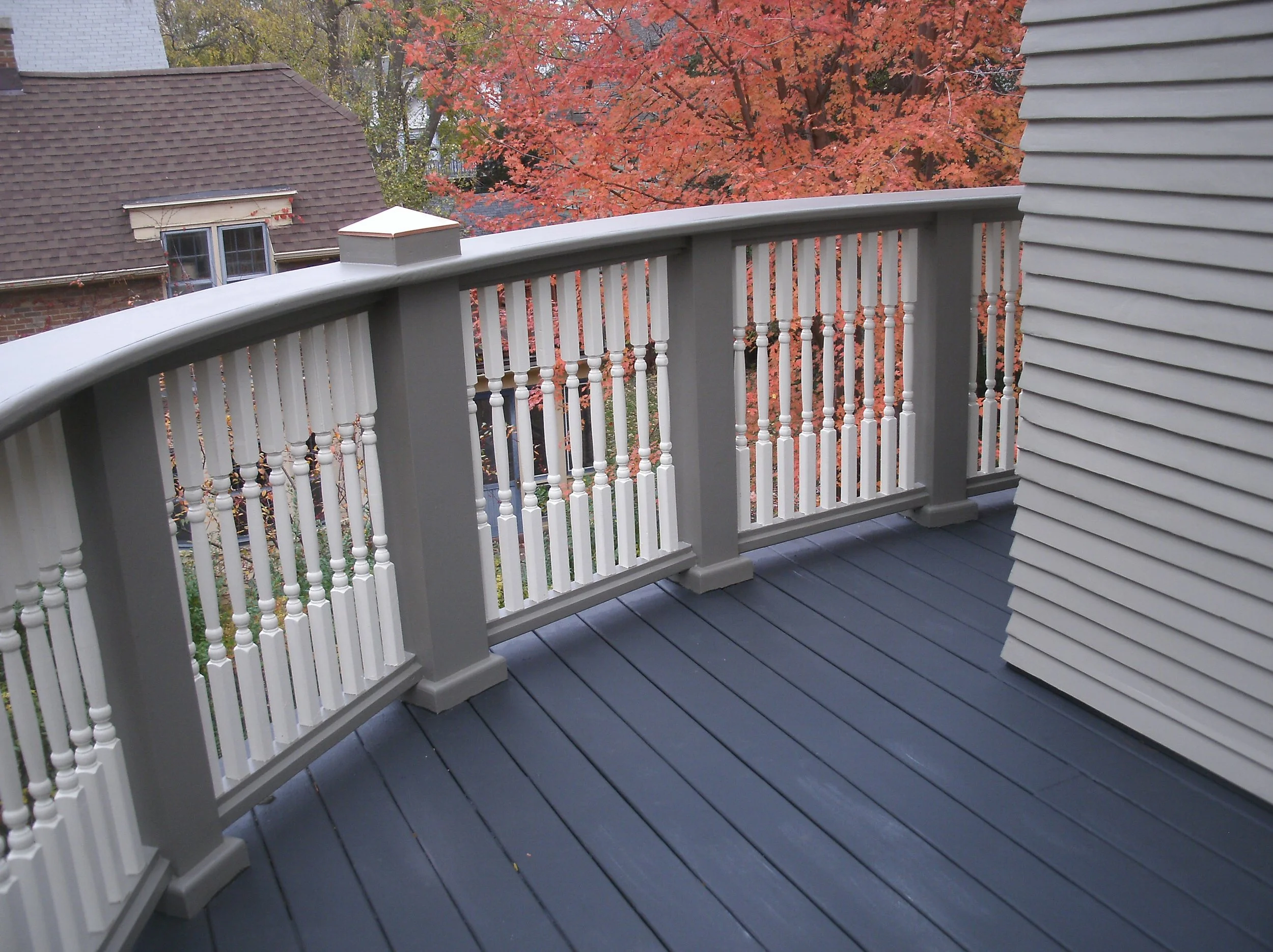 View of railing and repaired siding. Railing, decking, and siding painted.