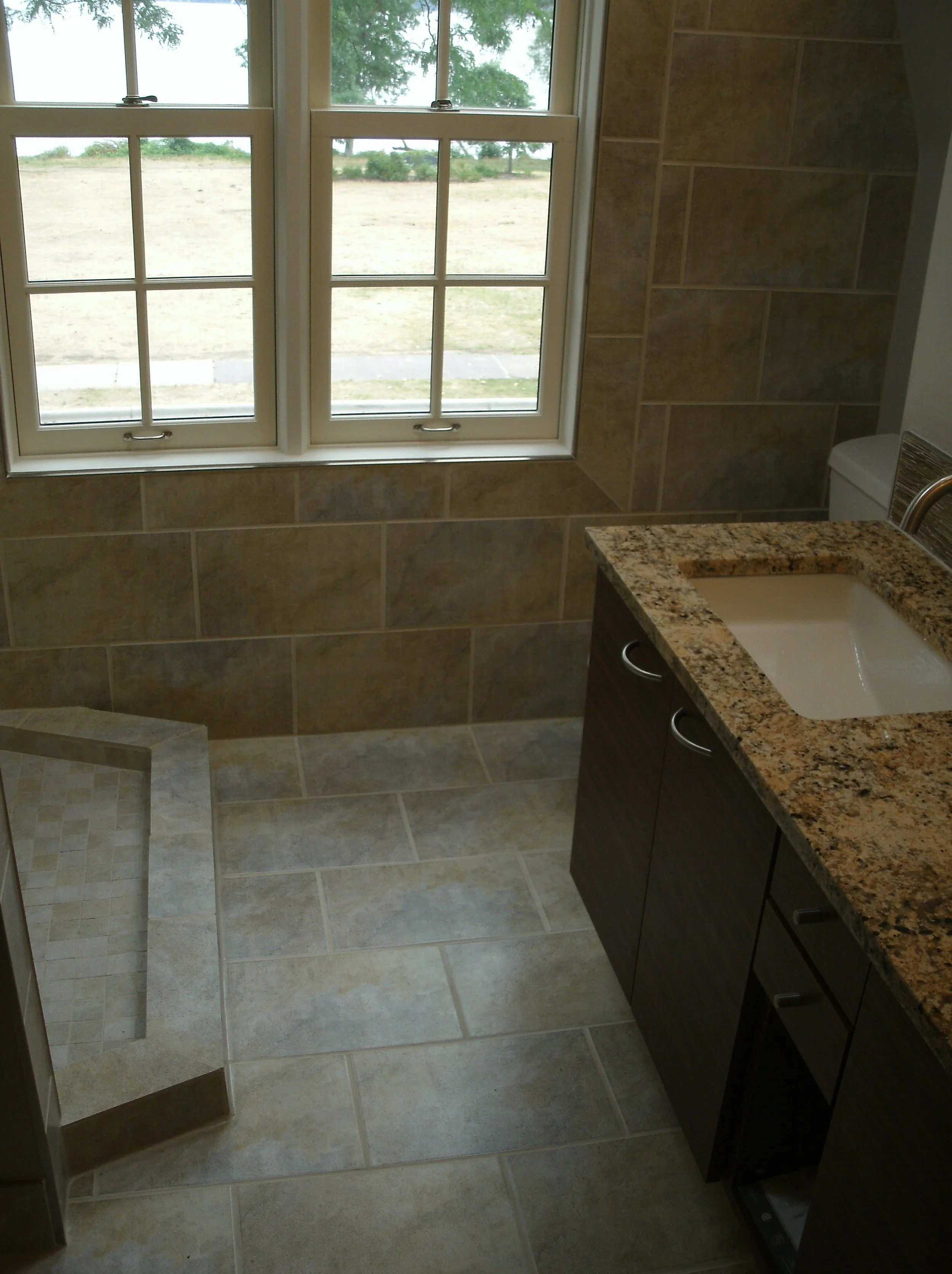View of the room with tiled shower curb