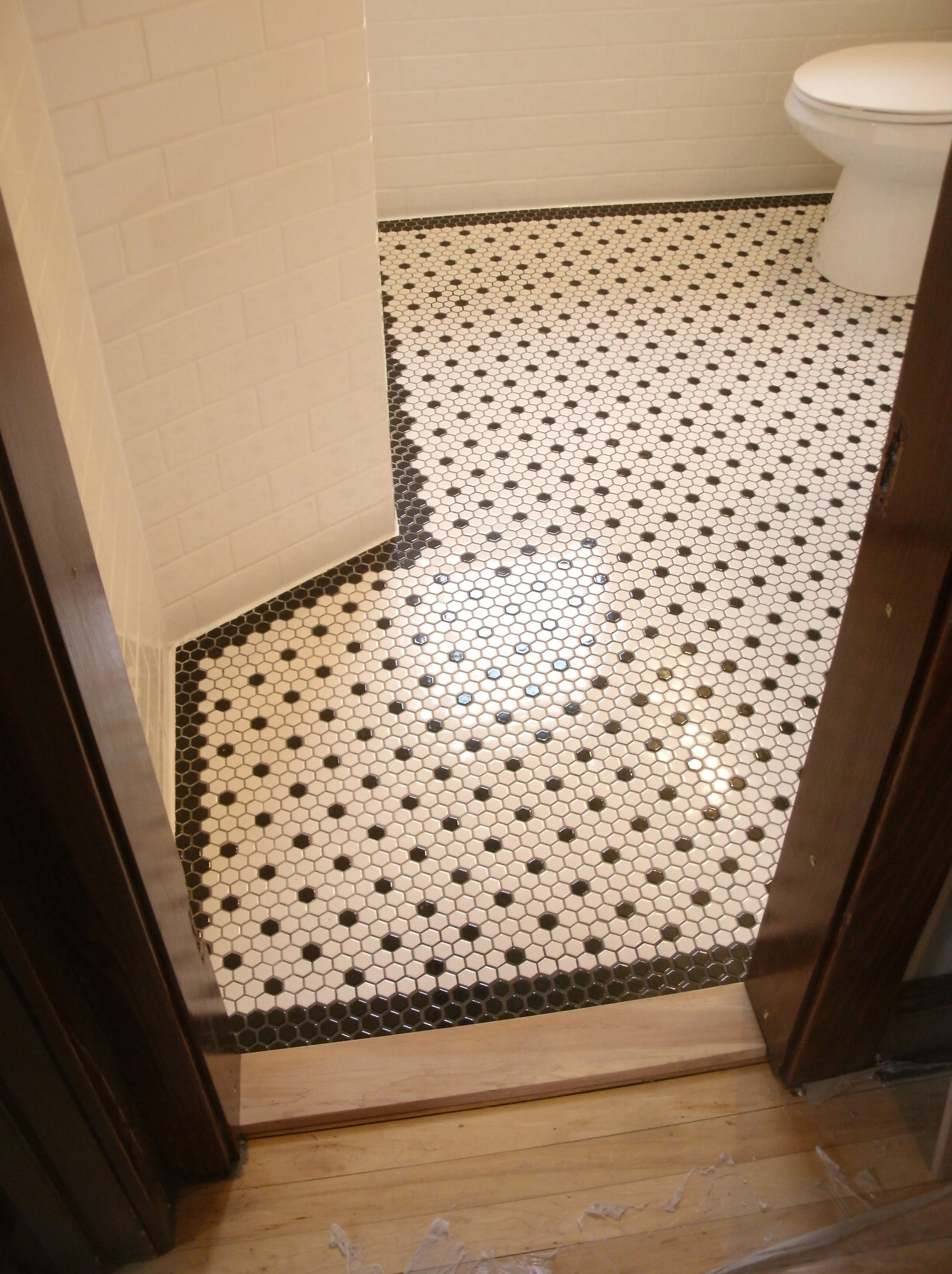 A more full view of the floor I tiled. Angled wall on left is a new shower wall.