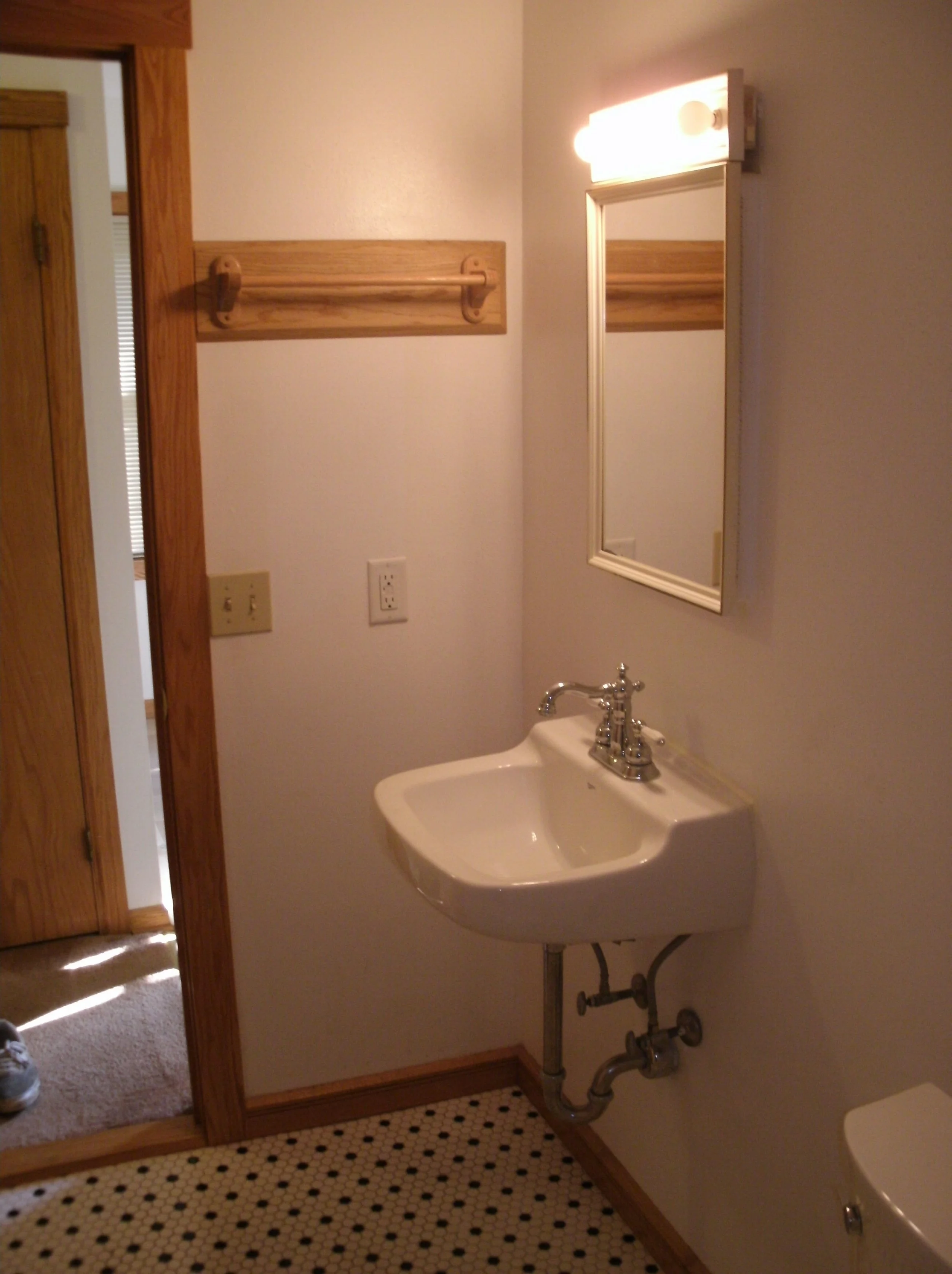 View of the sink, door trim, baseboards