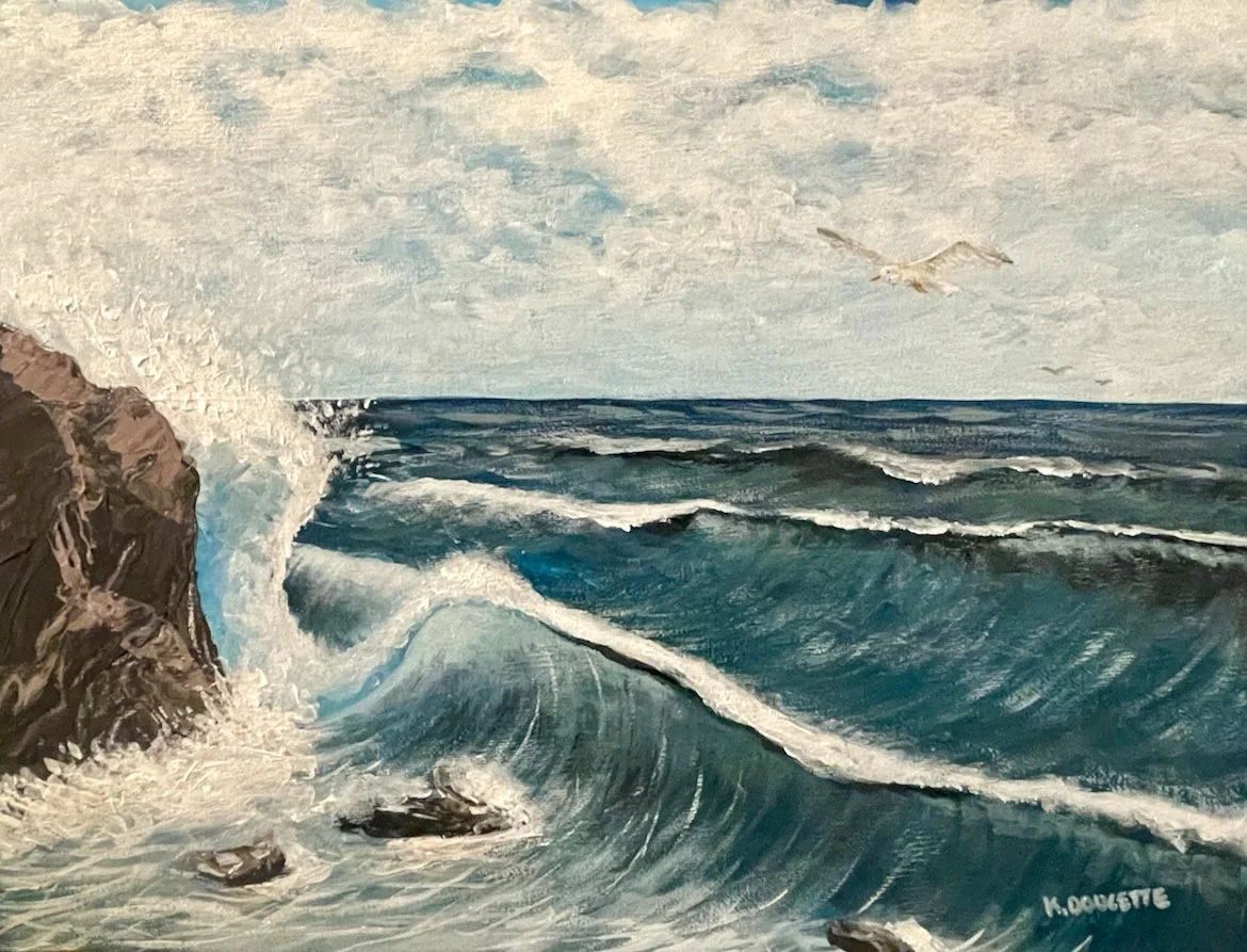 Ocean waves crashing against rocky cliffs with a seagull flying above under a cloudy sky.