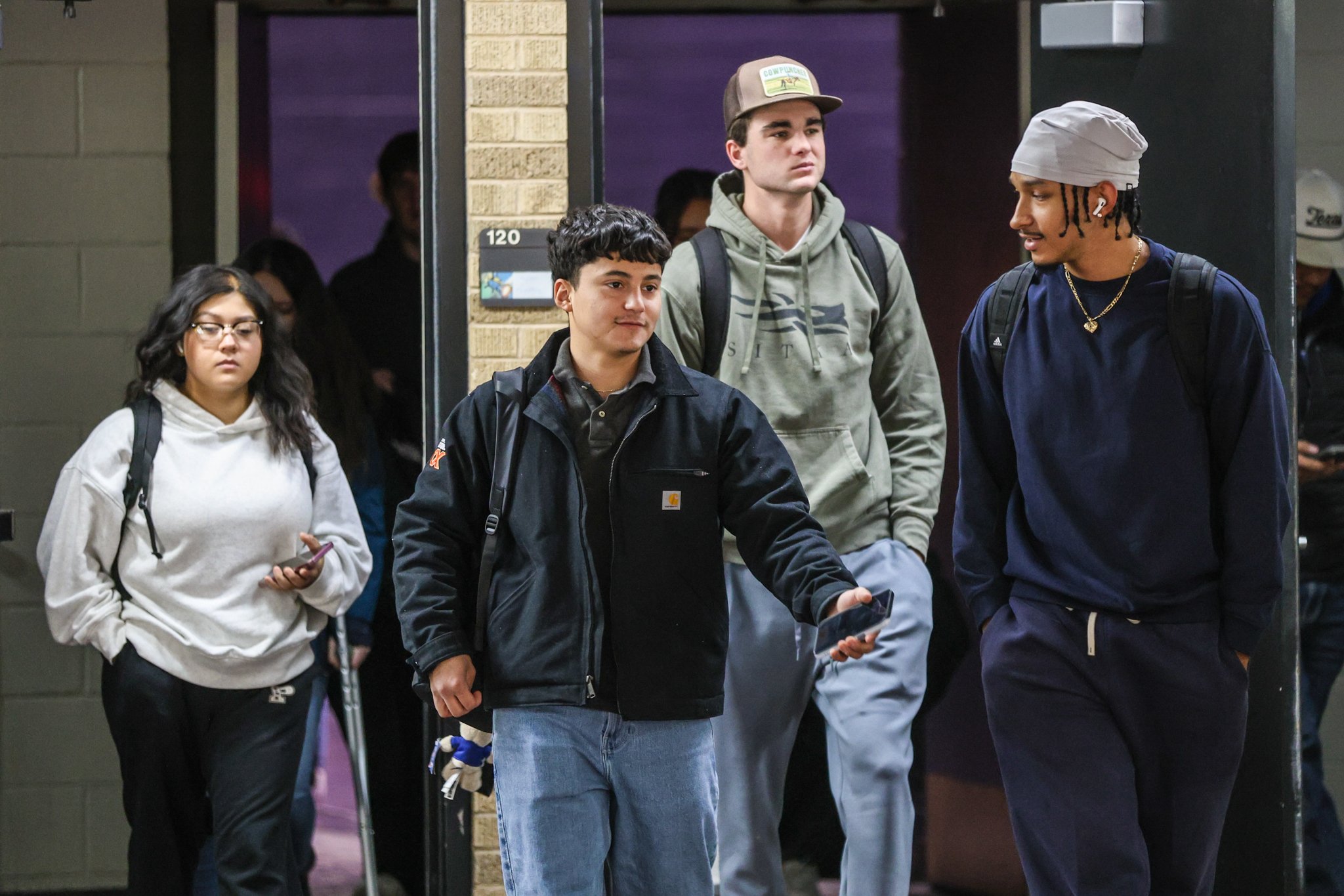 Walking out of class, Aguirre talks to one of his friends inside the Texas Tech Student Union building.