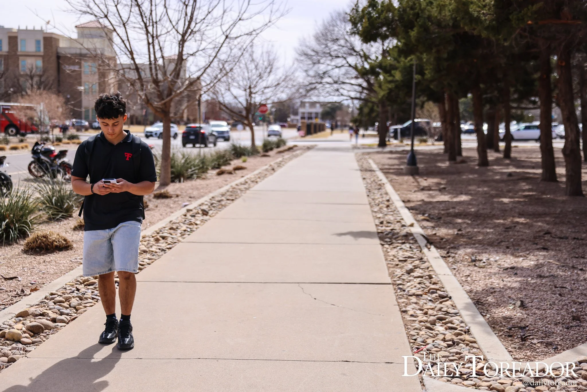 Aguire walks to his Business Management classes before cutting up clients in the second half of his day.