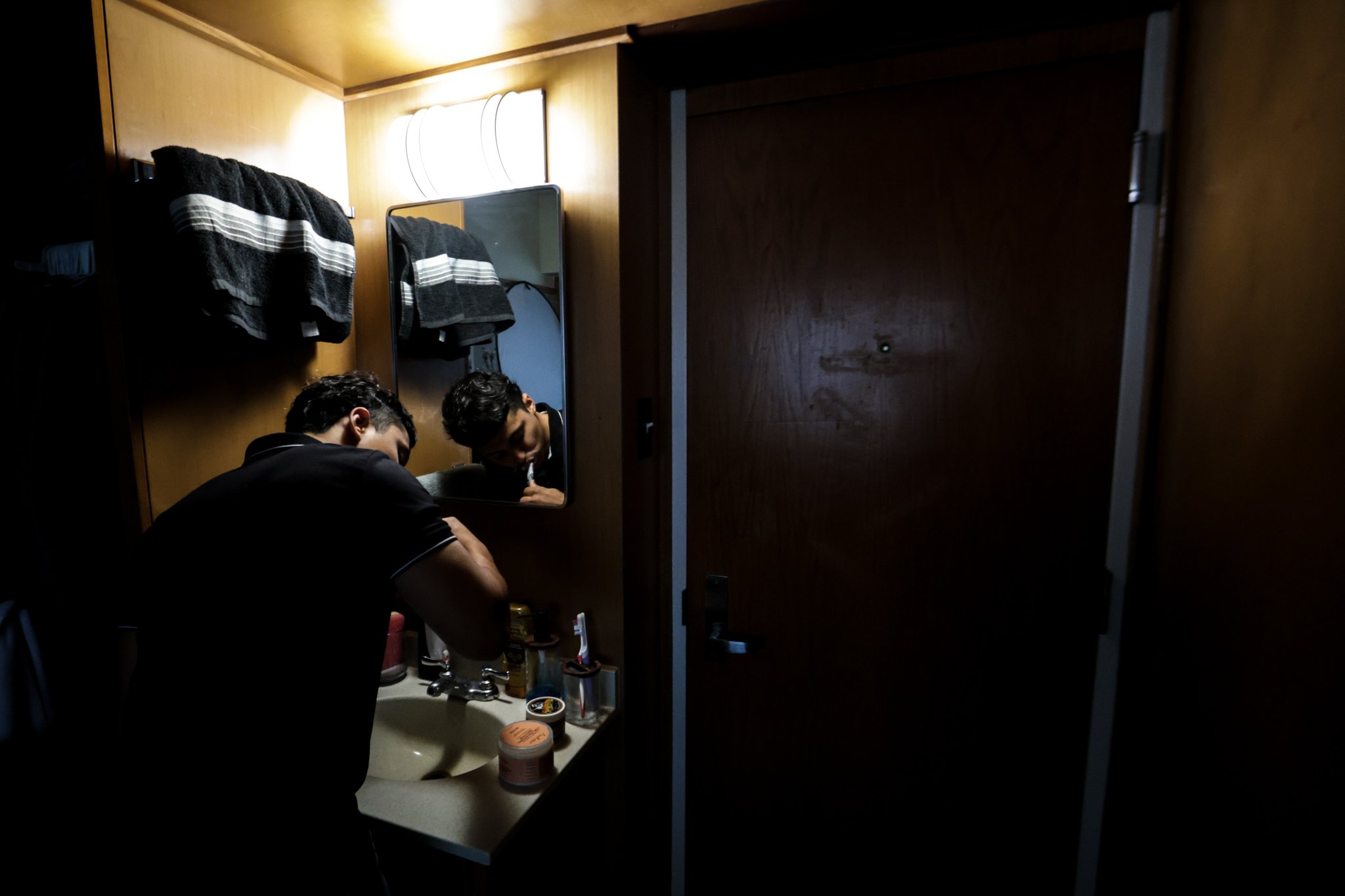 Juan Aguirre, a Dallas native, brushes his teeth before starting his day full of classes and appointments.