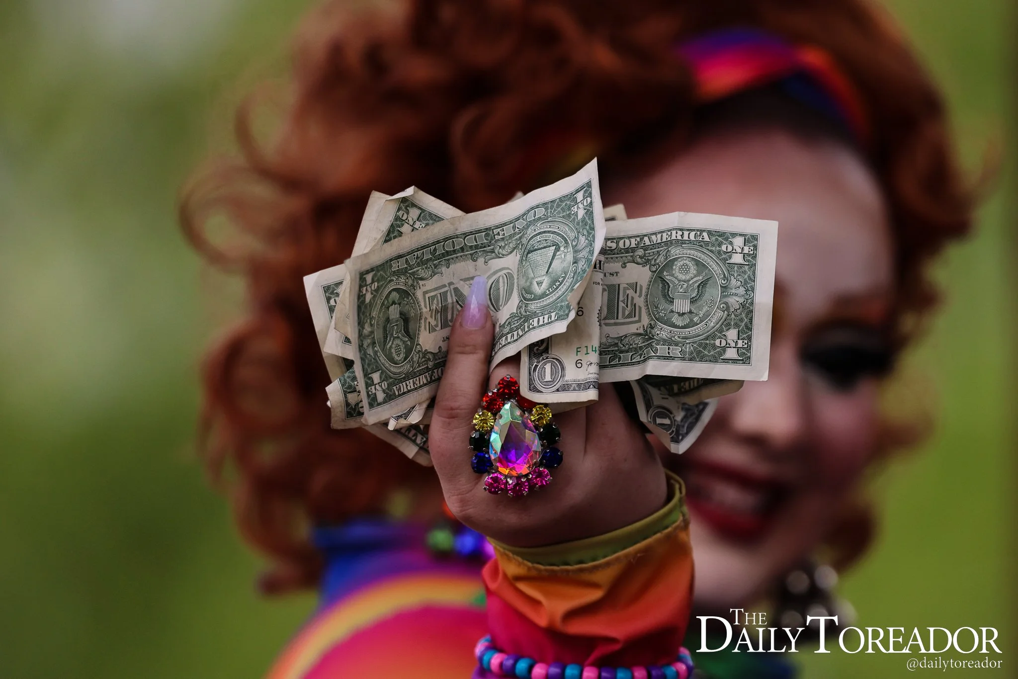 Lilianna B. Davenport, a Lubbock drag queen, holds money while performing at Lubbock PRIDE's Pride Fest at the Louise Hopkins Underwood Center for the Arts in downtown Lubbock, June 28, 2025.