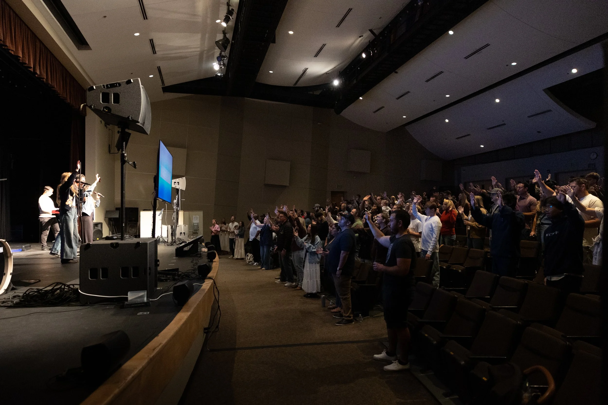 Picture of auditorium of people worshiping during a church service
