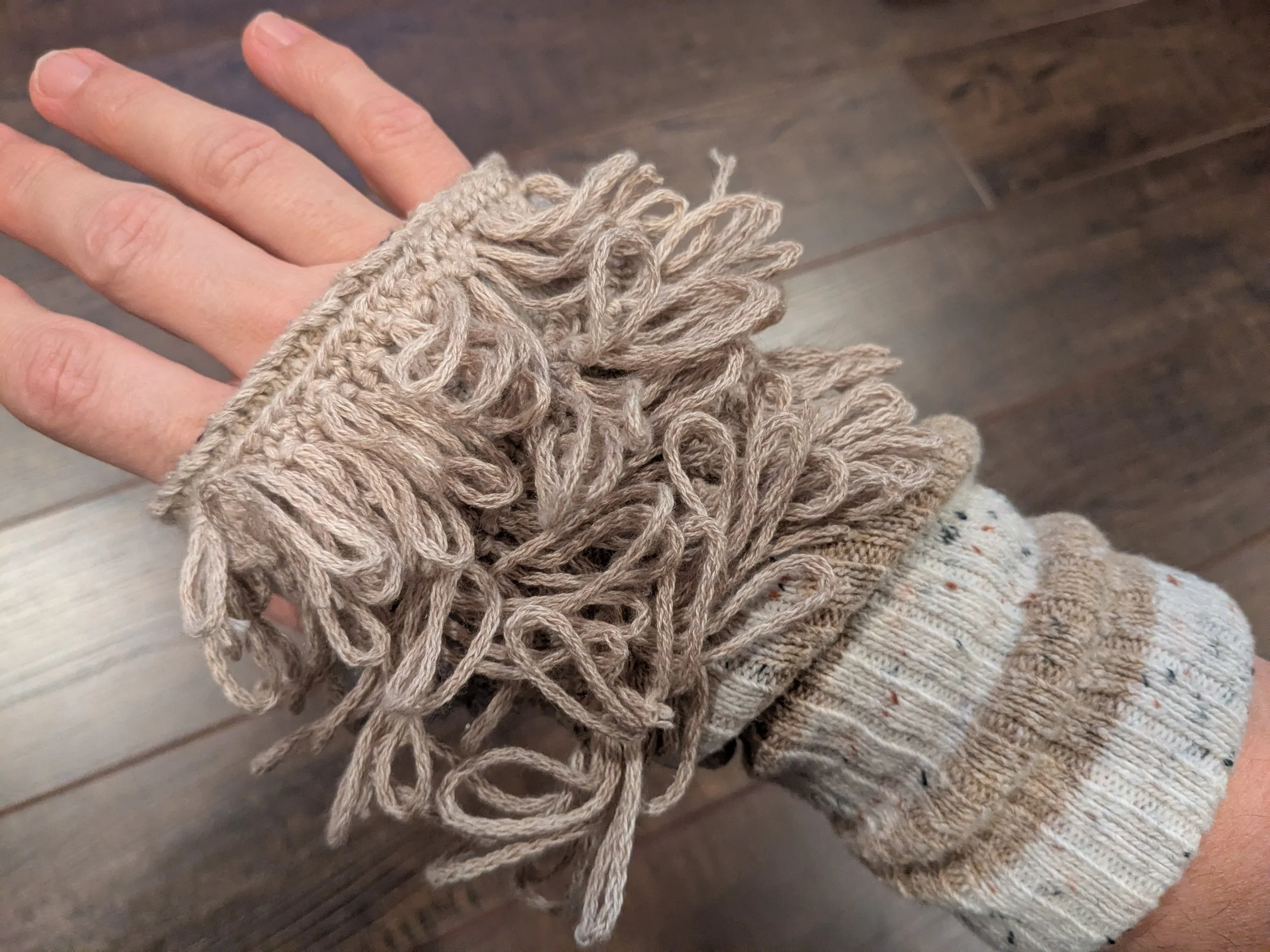 Reworked socks into fingerless gloves.