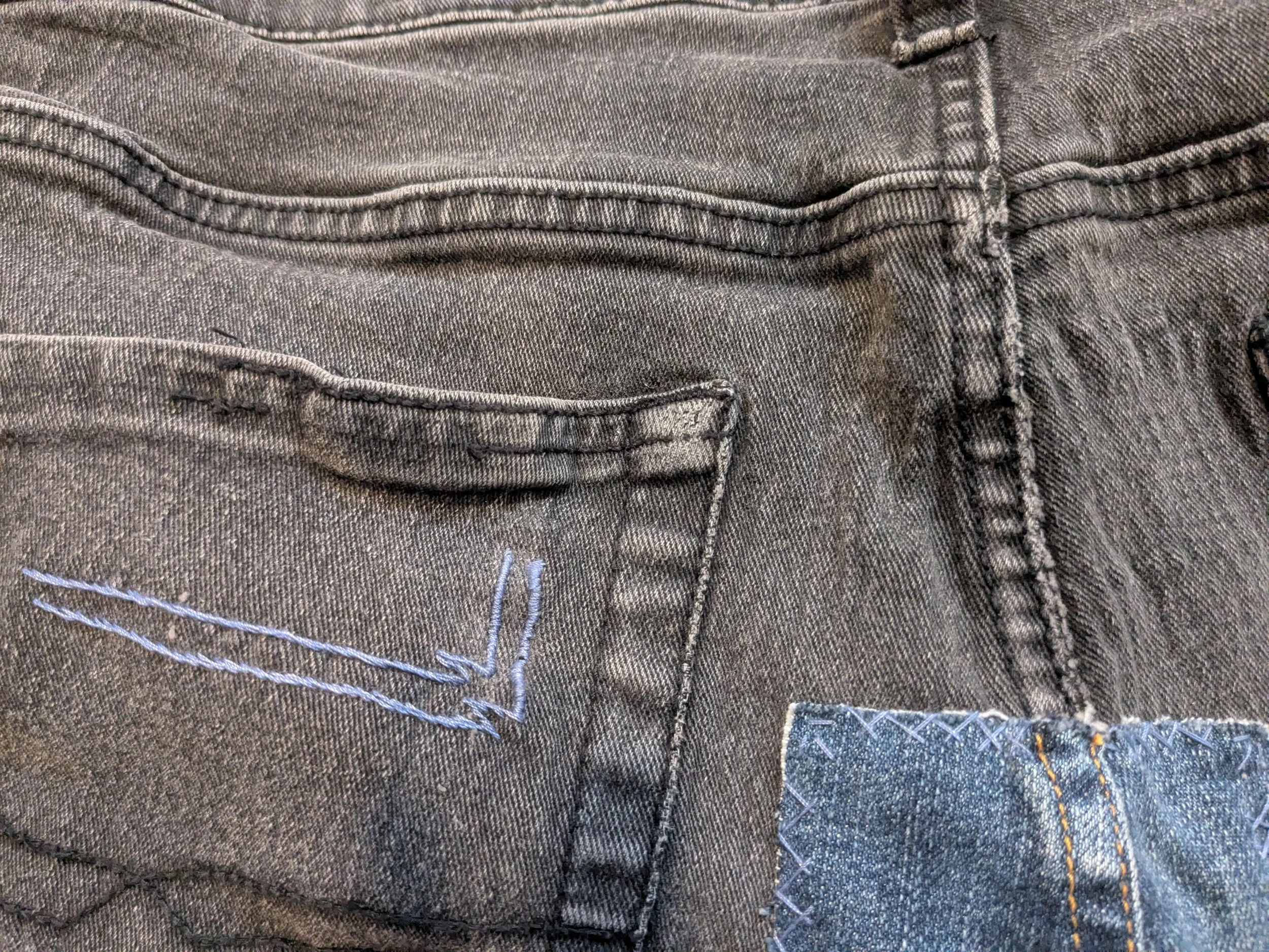 Reinforcing the back pocket with embroidery to prevent holes from developing.