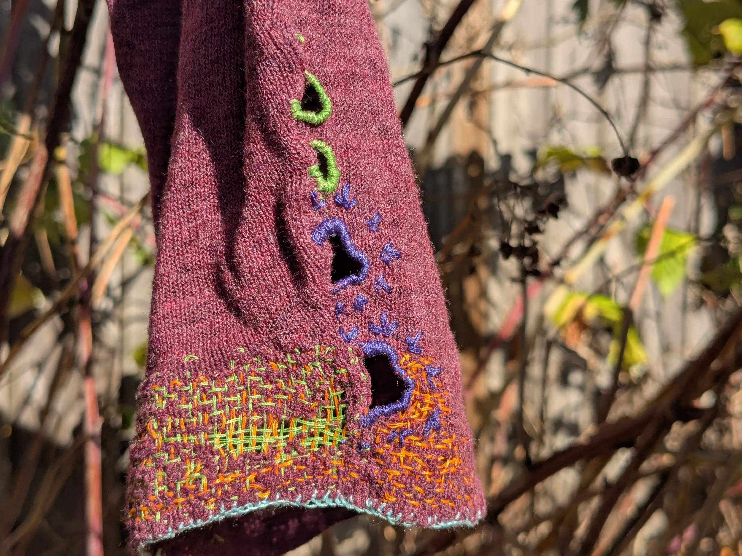 Visible needle weaving as mending and repair.