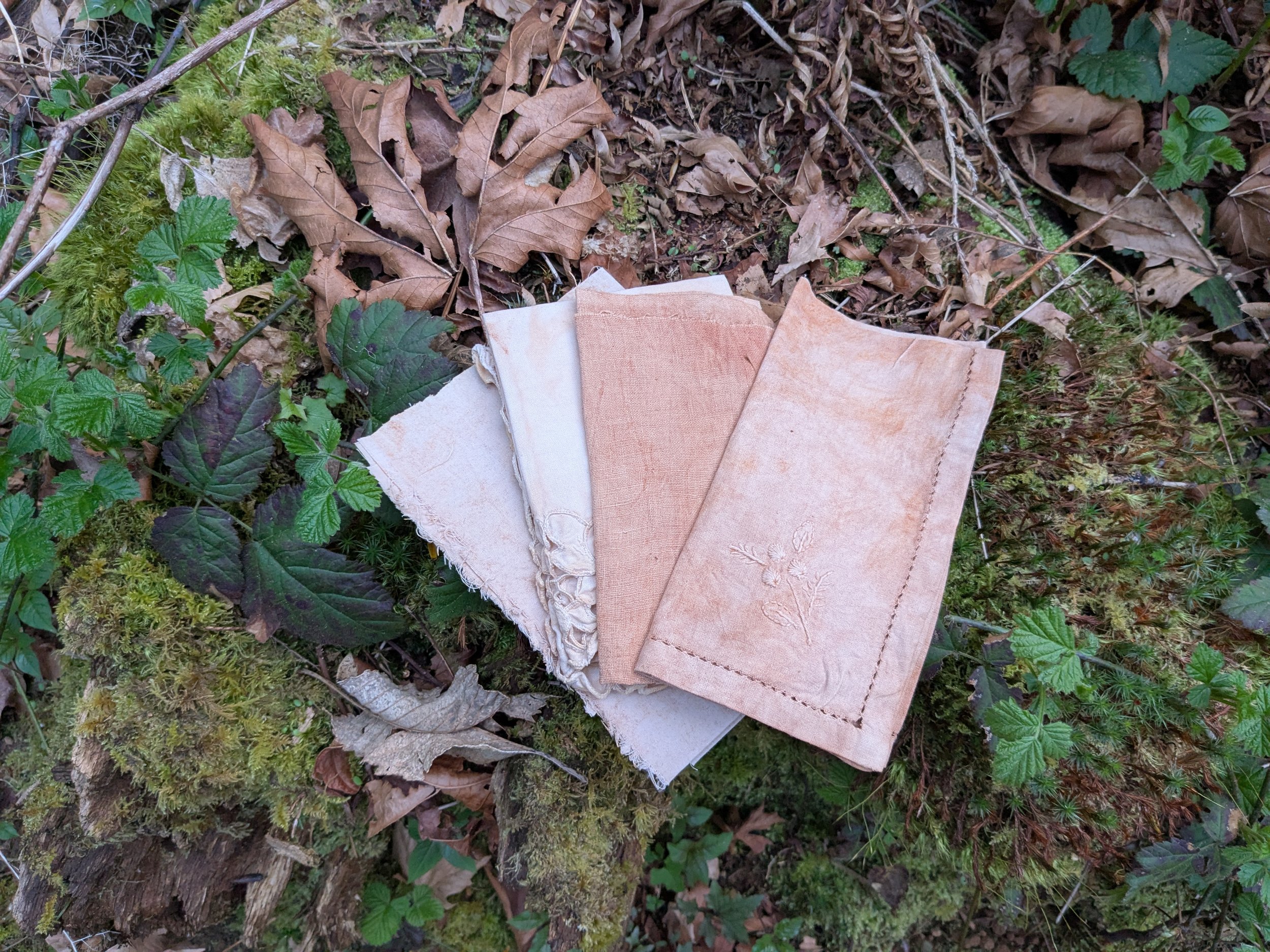 Range of rusty orange swatches, naturally dyed upcycled fabric.