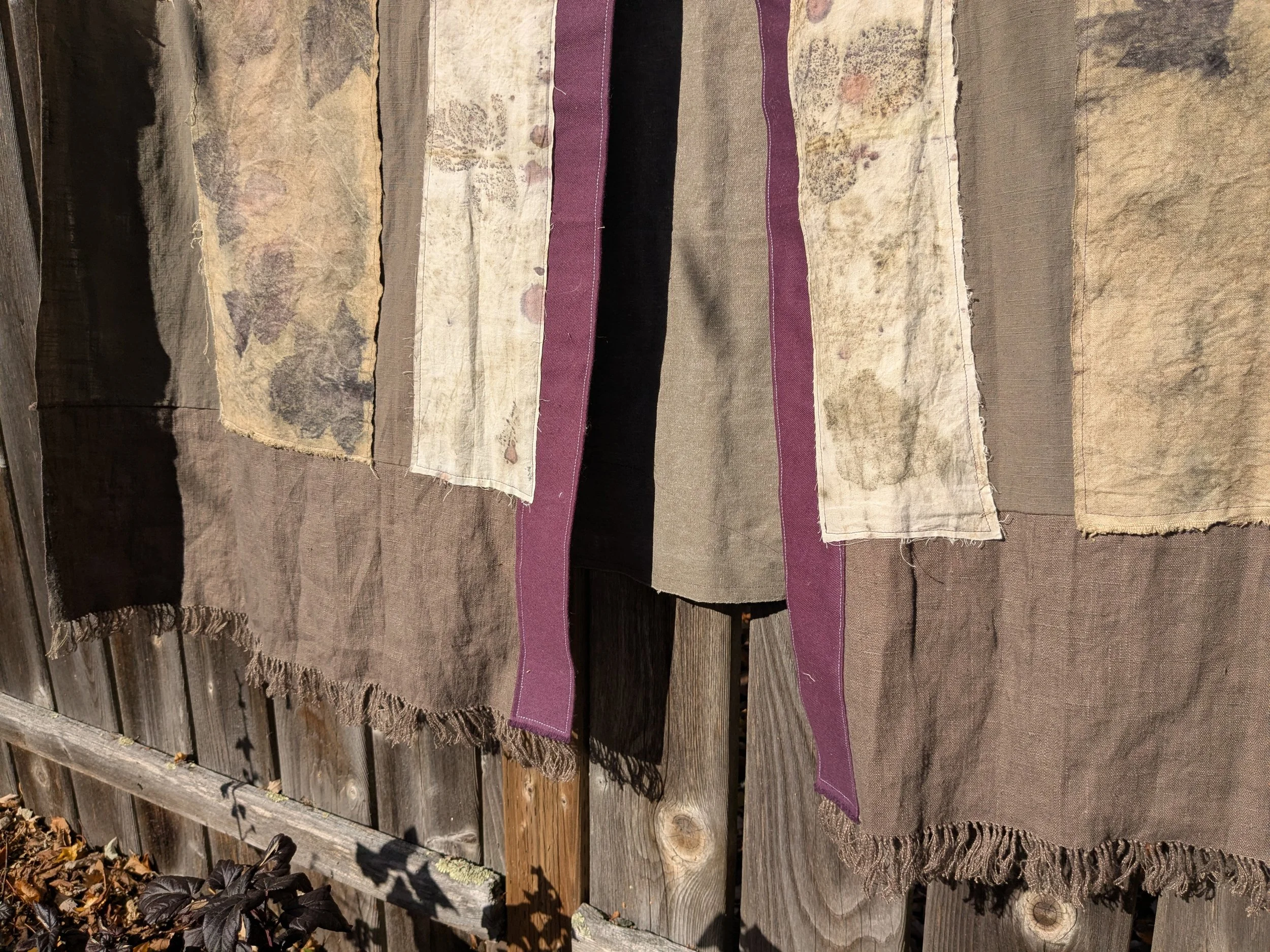 Autumn shawl with eco-printed panels and upcylced fabric and notions.