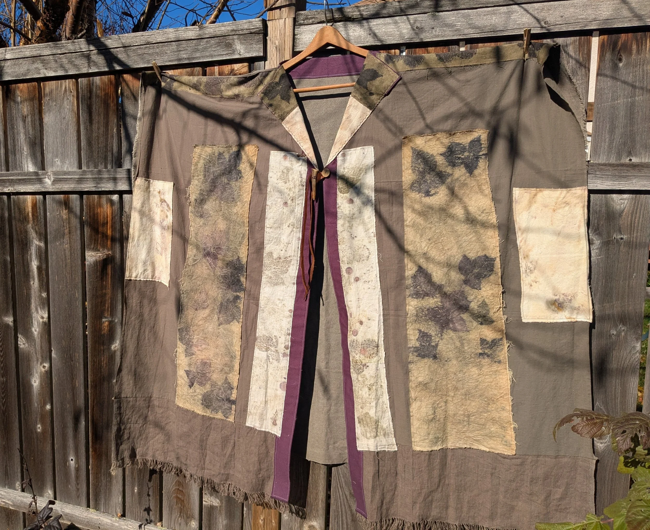 Autumn shawl with eco-printed panels and upcylced fabric and notions.
