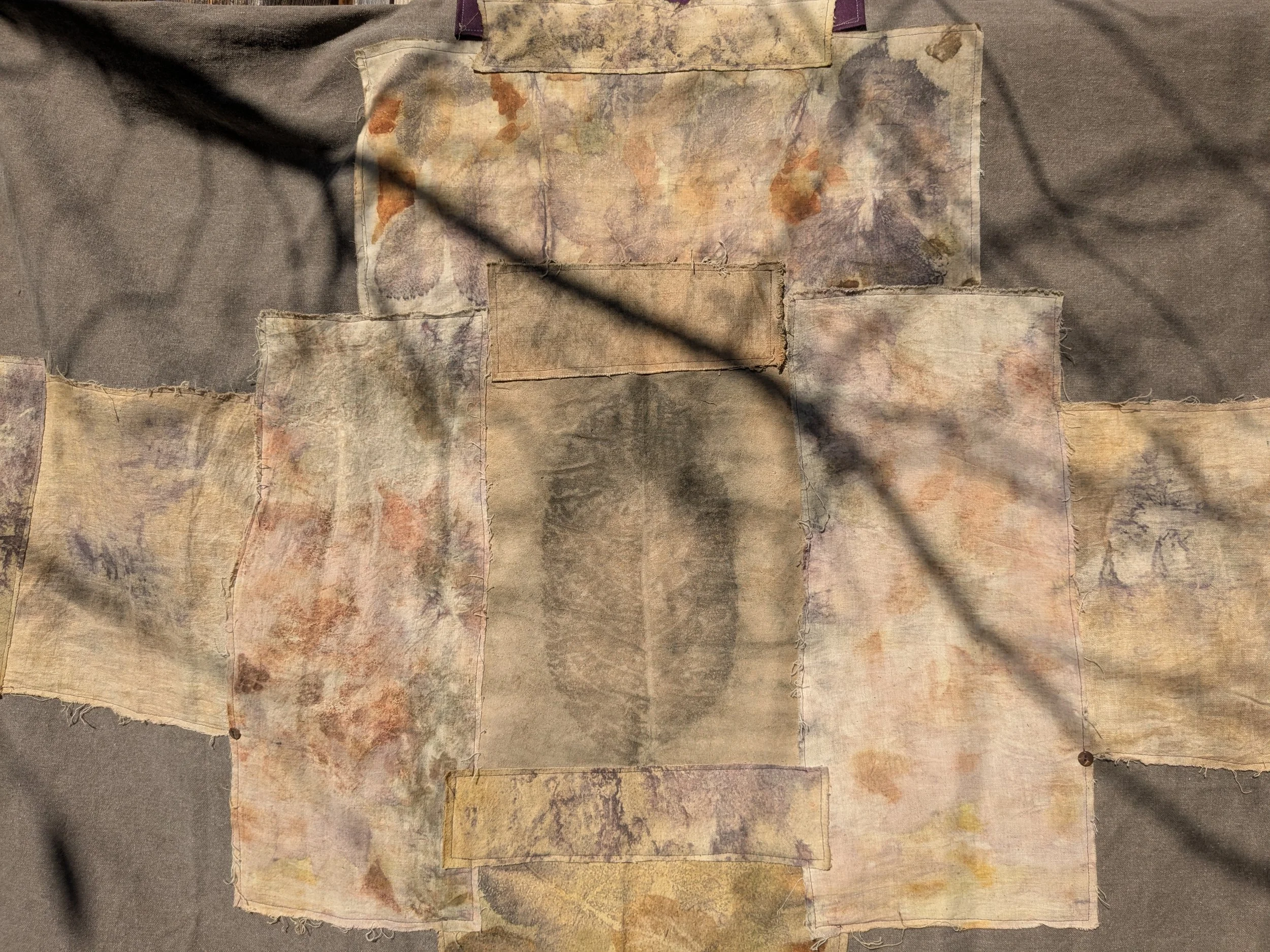 Autumn shawl with eco-printed panels and upcylced fabric and notions.