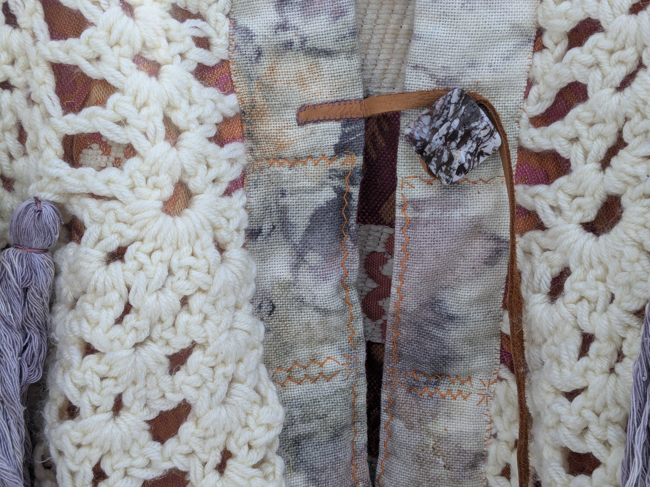 Cozy winter shawl with fully upcycled fabric, close-up of handsewing and clasp..