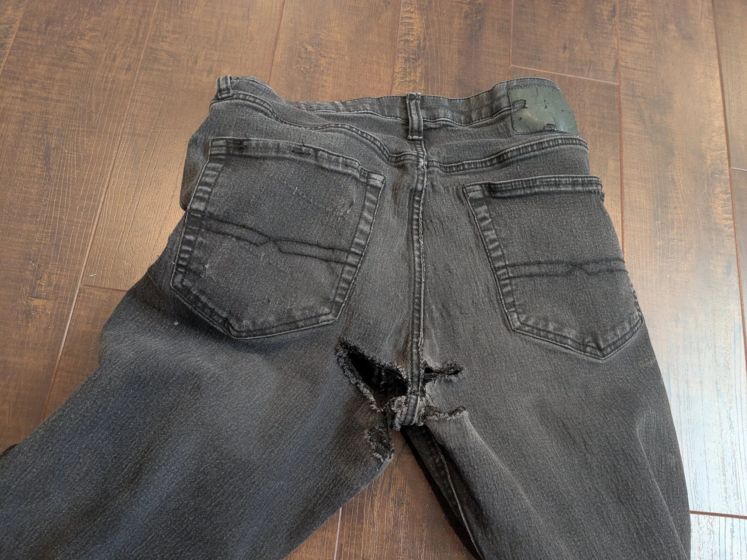 Torn seat of jeans to be mended.