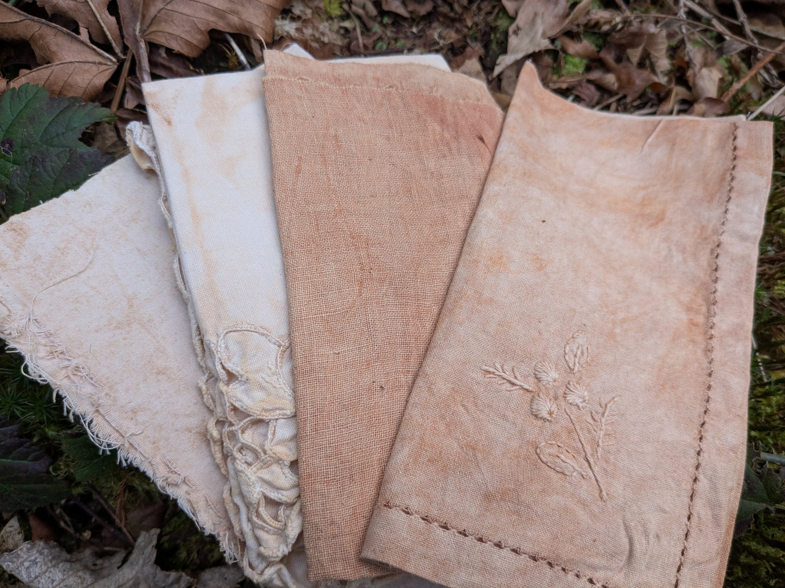 Range of rusty orange swatches, naturally dyed upcycled fabric.
