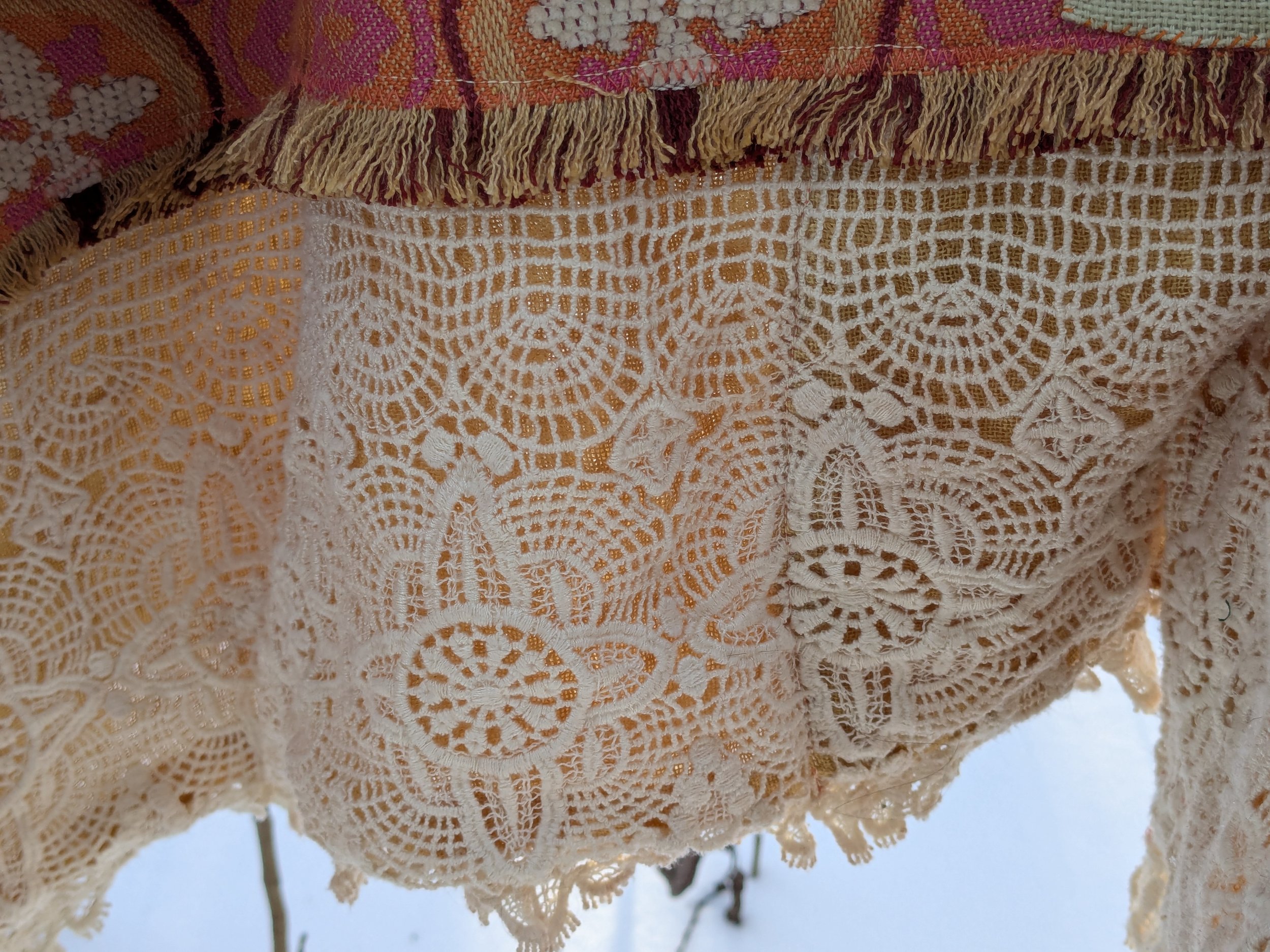 Cozy winter shawl with fully upcycled fabric, view of onion dyed border.