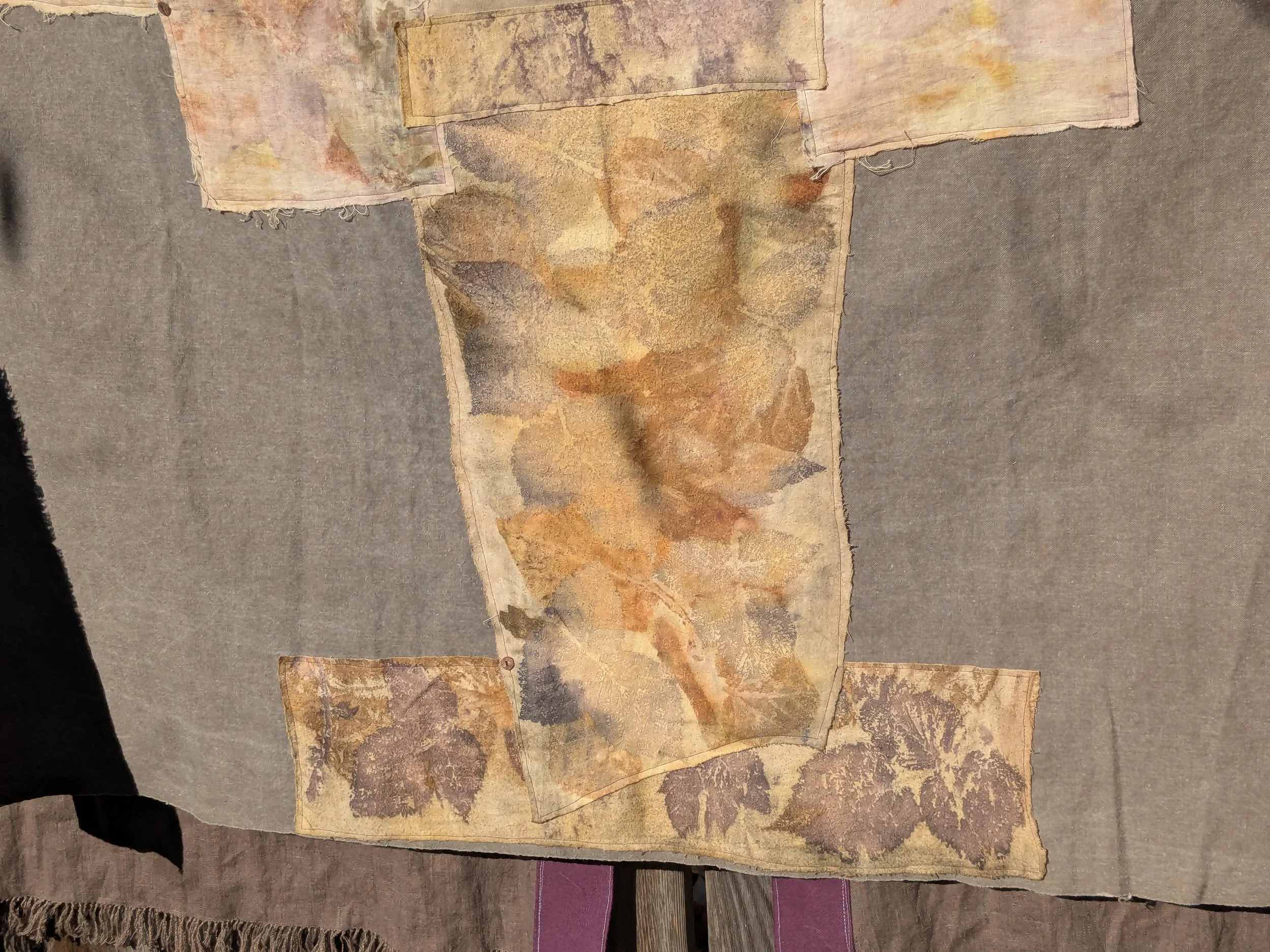 Autumn shawl with eco-printed panels and upcylced fabric and notions.
