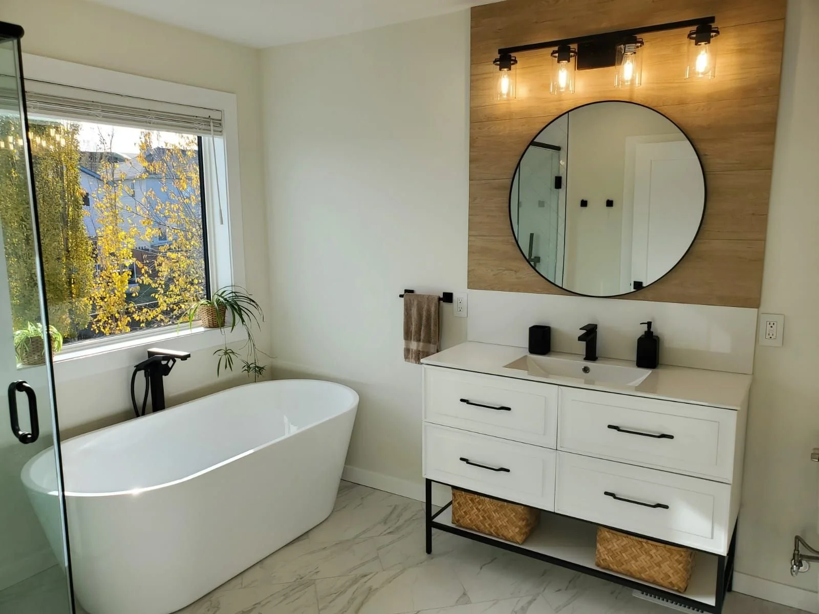 Freestanding soaker tub and custom vanity plumbing installation in a Calgary bathroom renovation