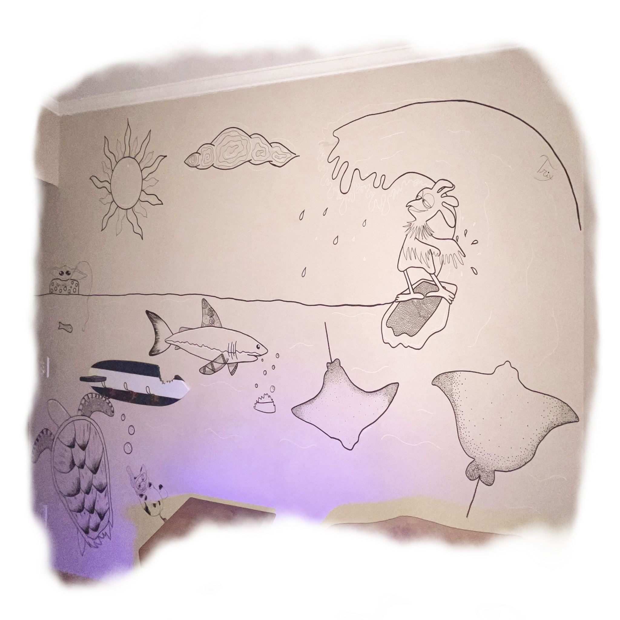 A hand-drawn illustration on a wall shows a sunny sky with clouds, a fish, a whale, stingray, and other sea creatures, with a person surfing on a large wave under the sun.