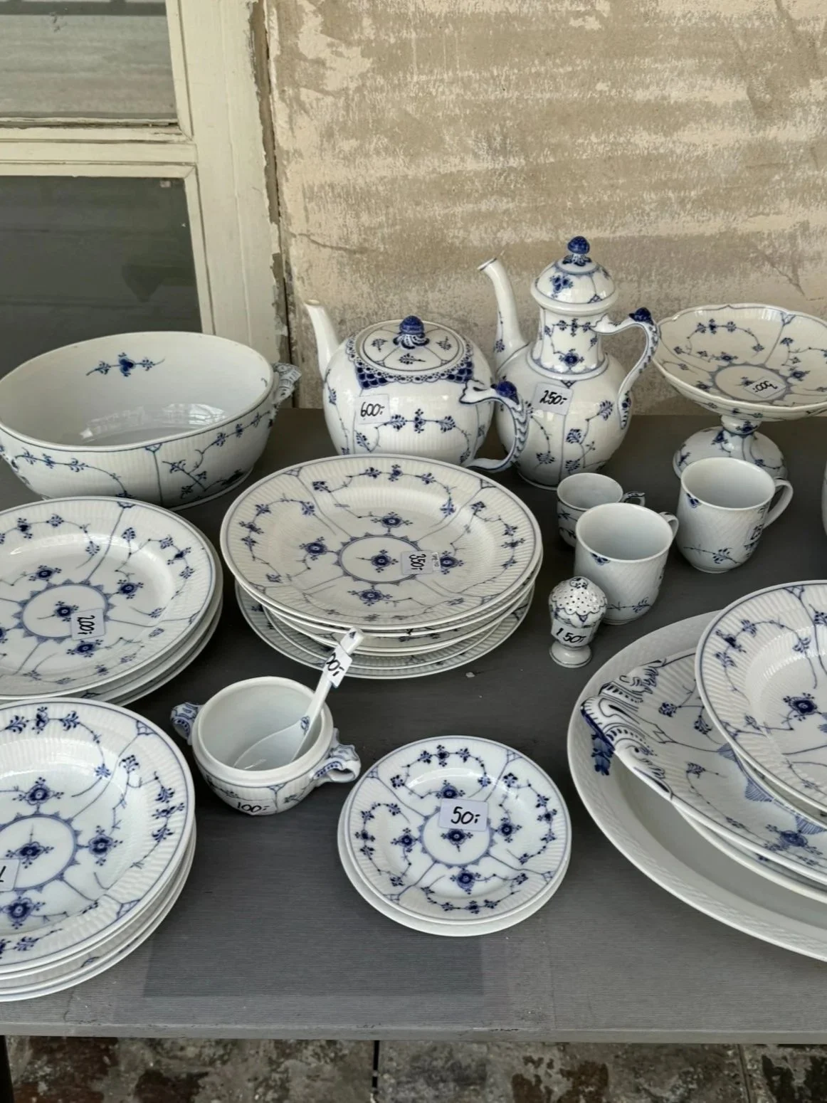 Royal Copenhagen porcelain pieces outside an antique store in Copenhagen, Denmark. Read about how these blue-and-white wares travel around the world and gain global recognition.