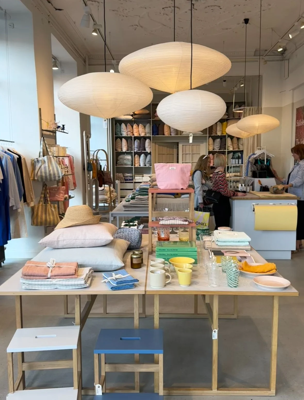 A colourful store filled with a range of kitchen utensils, bedroom textiles and furniture, all showcasing Danish design.