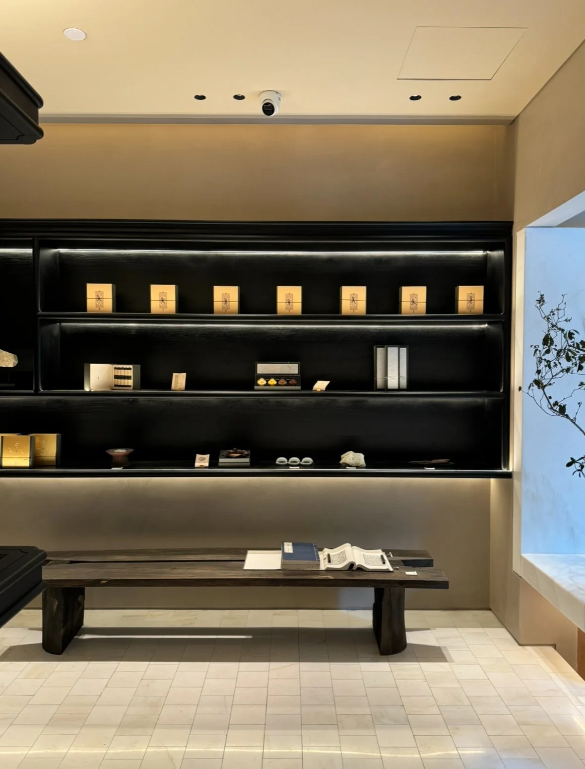 Interior view of Tangsuo's store at the Bund, Shanghai, showcasing black lacquer shelves filled with gift boxes.