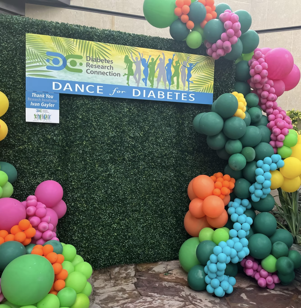 Decorative balloon arch with a "Dance for Diabetes" banner by Diabetes Research Connection.