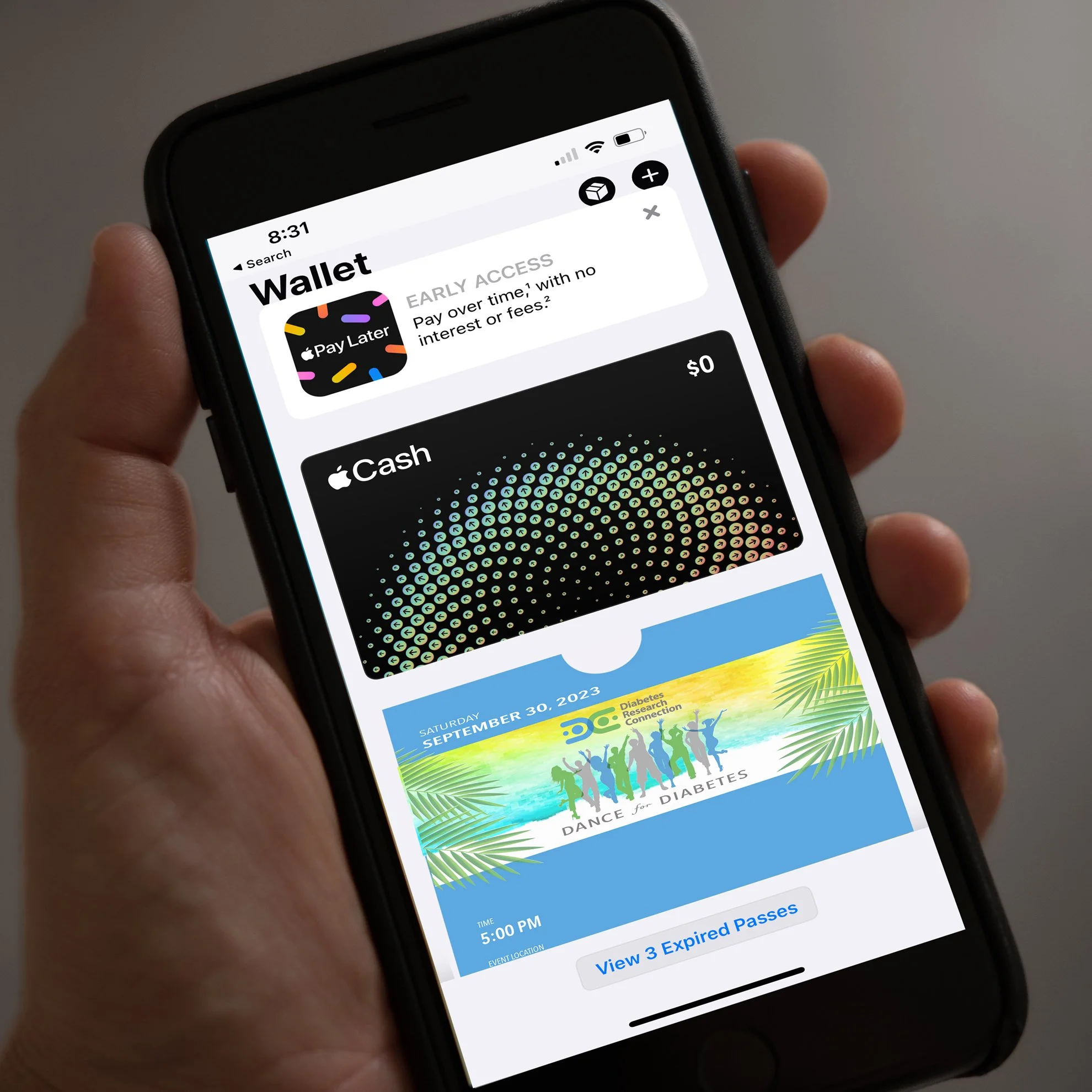 Close-up of a smartphone screen showing a digital wallet app interface with Apple Pay Later, Apple Cash, and an event ticket for "Dance for Diabetes".