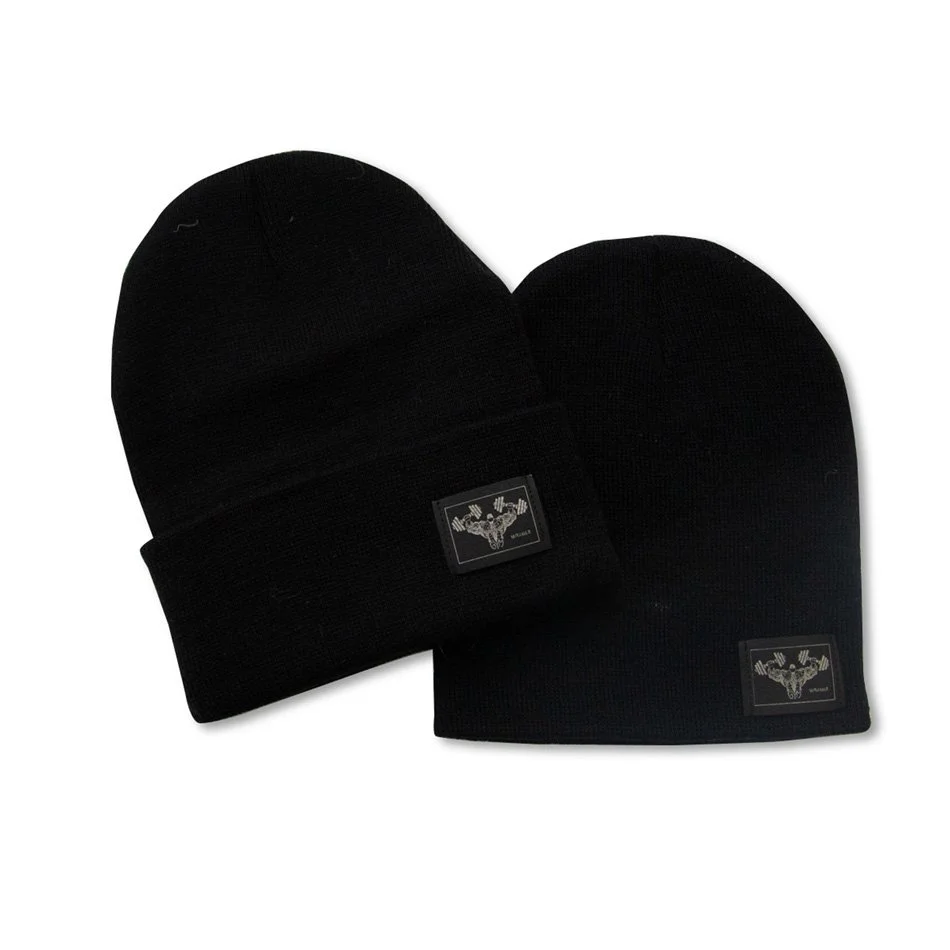 Two black beanies with logo patches on a white background.