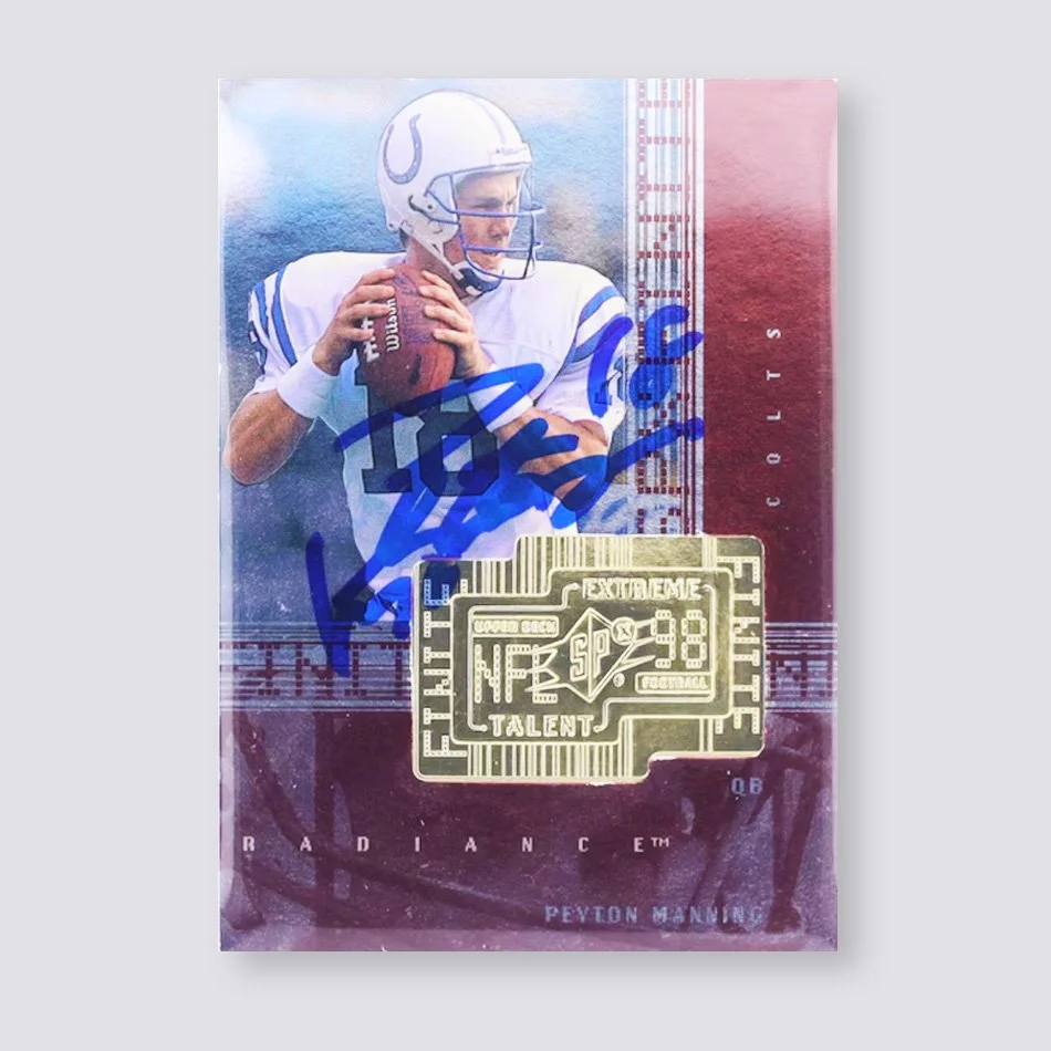 Football trading card featuring a player in a white and blue uniform holding a football, with autograph on the card. The card displays an “Extreme Talent” emblazonment and NFL branding.