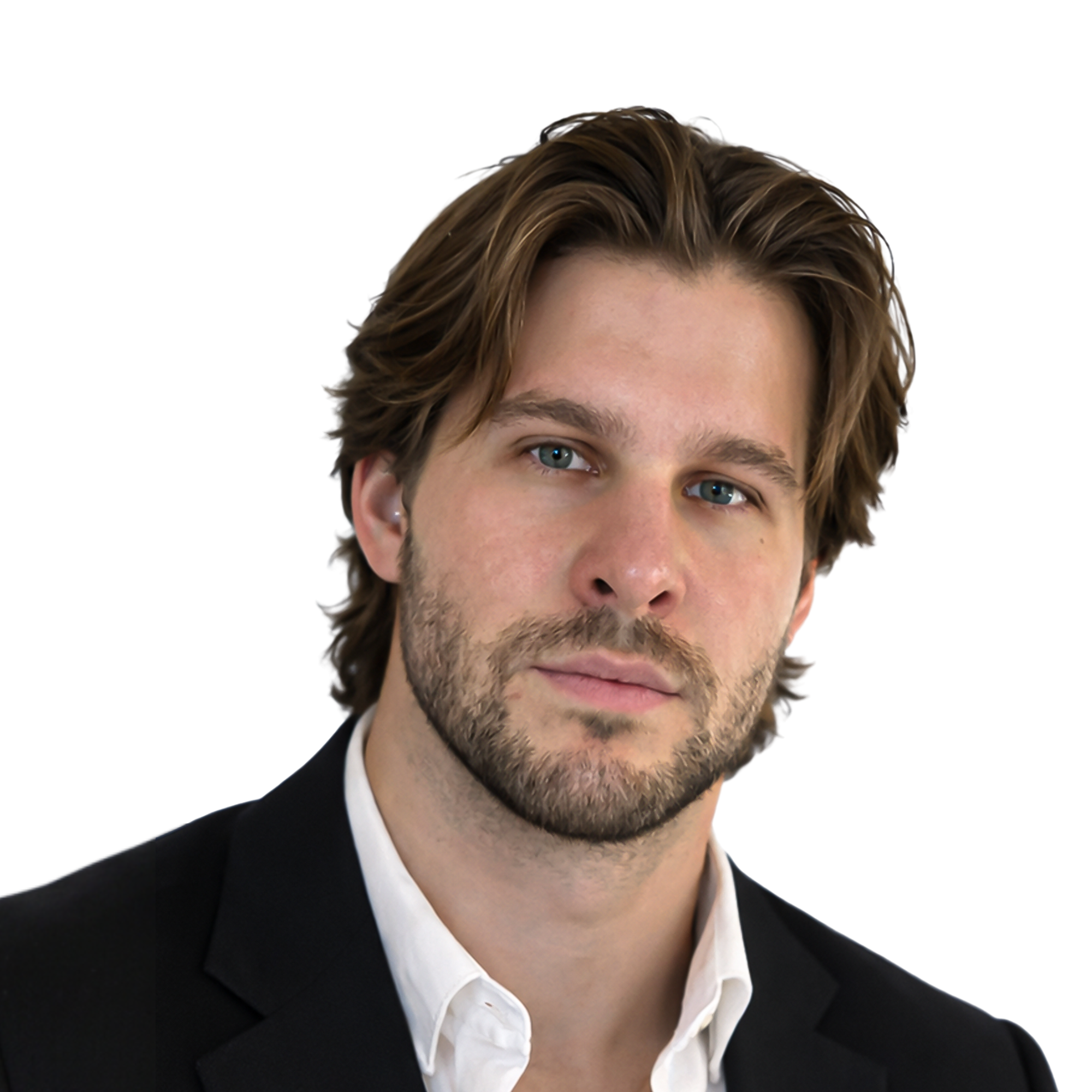 Close-up of a man's face with brown hair, blue eyes, and light skin, wearing a black suit and white shirt, against a white background.