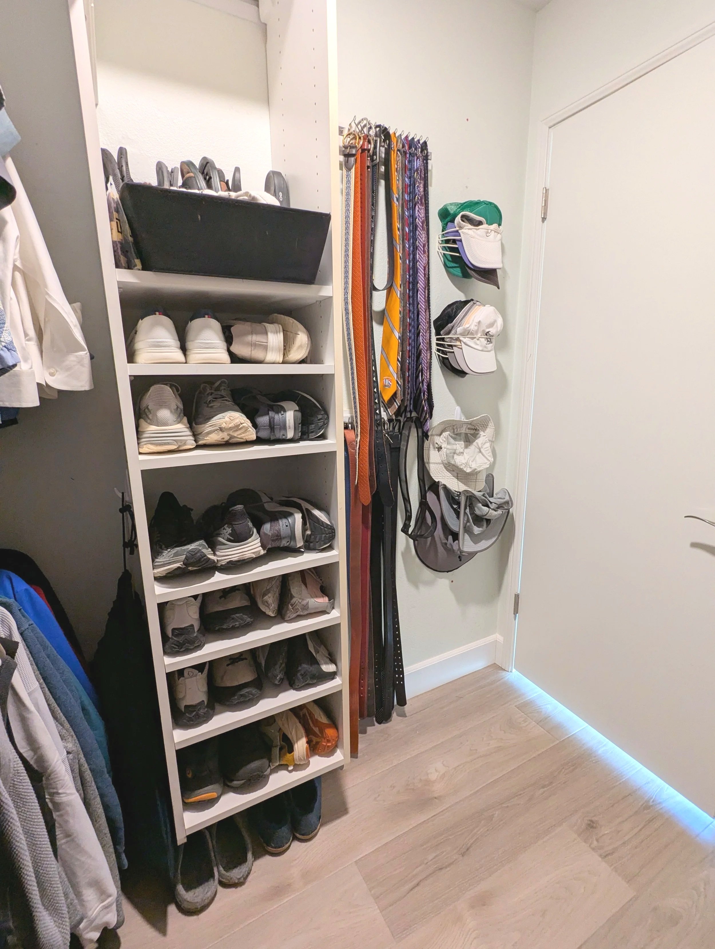 Before-and-after style walk-in closet organization with built-in shelves and shoe storage by a professional organizer in San Diego.