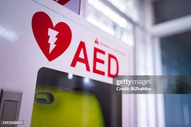 AED defibrillator station with a red heart and lightning bolt symbol