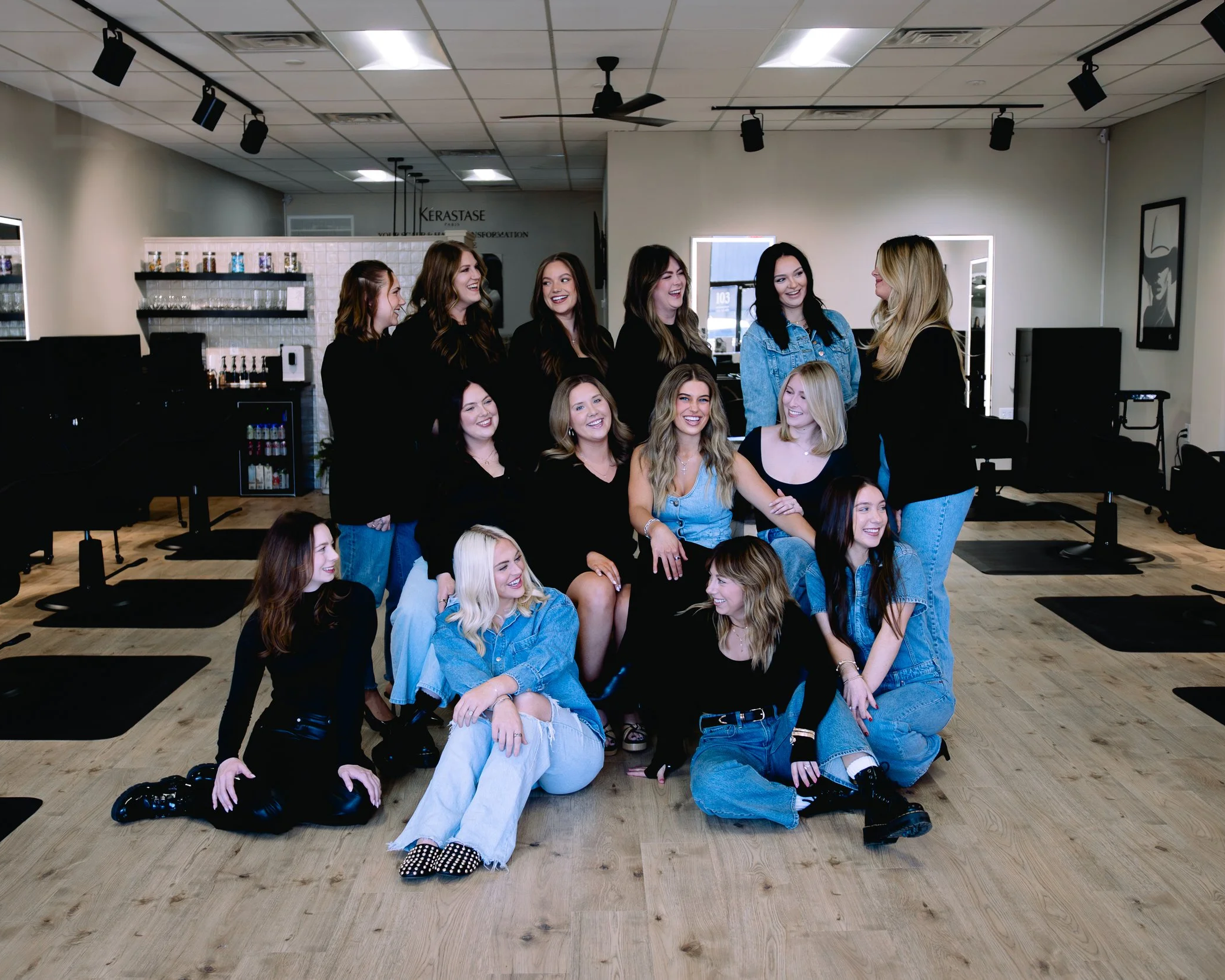 Team of luxury hair stylists laughing together at Capri Salon in Franklin, Tennessee